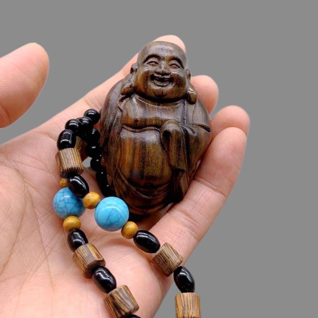 This 20th Century Chinese Wood Carving Maitreya Buddha Bracelet is a spiritually inspired piece of craftsmanship, blending traditional artistry with deep Buddhist symbolism. Each bead is carefully carved from fine wood, featuring the joyful and