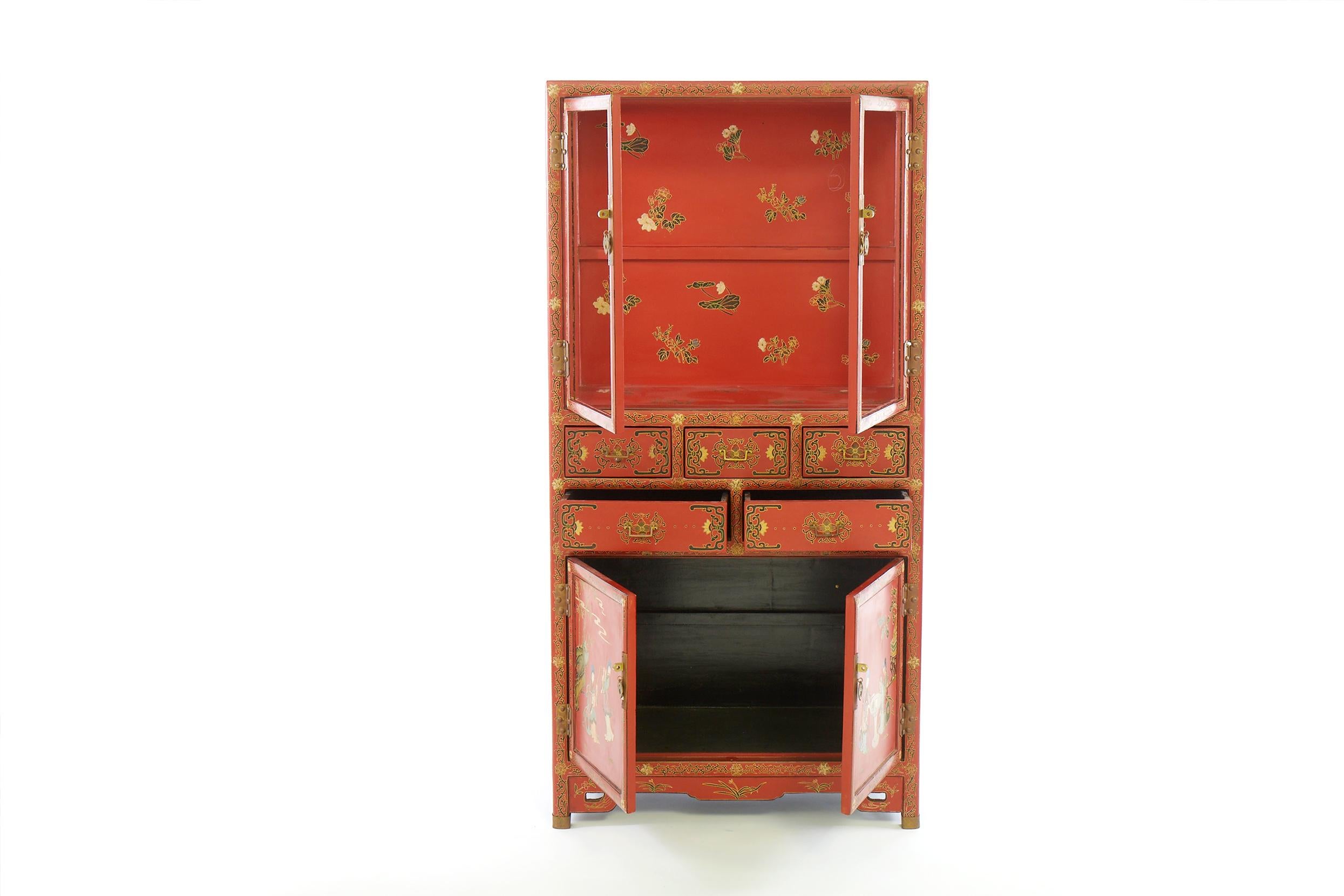 Mid 20th century hand painted chinoiserie style chinese lacquered cabinet / vitrine. The cabinet features two upper glazed drawers, five middle drawers with two lower doors and brass hardware. The cabinet comes with one glass shelve for the upper