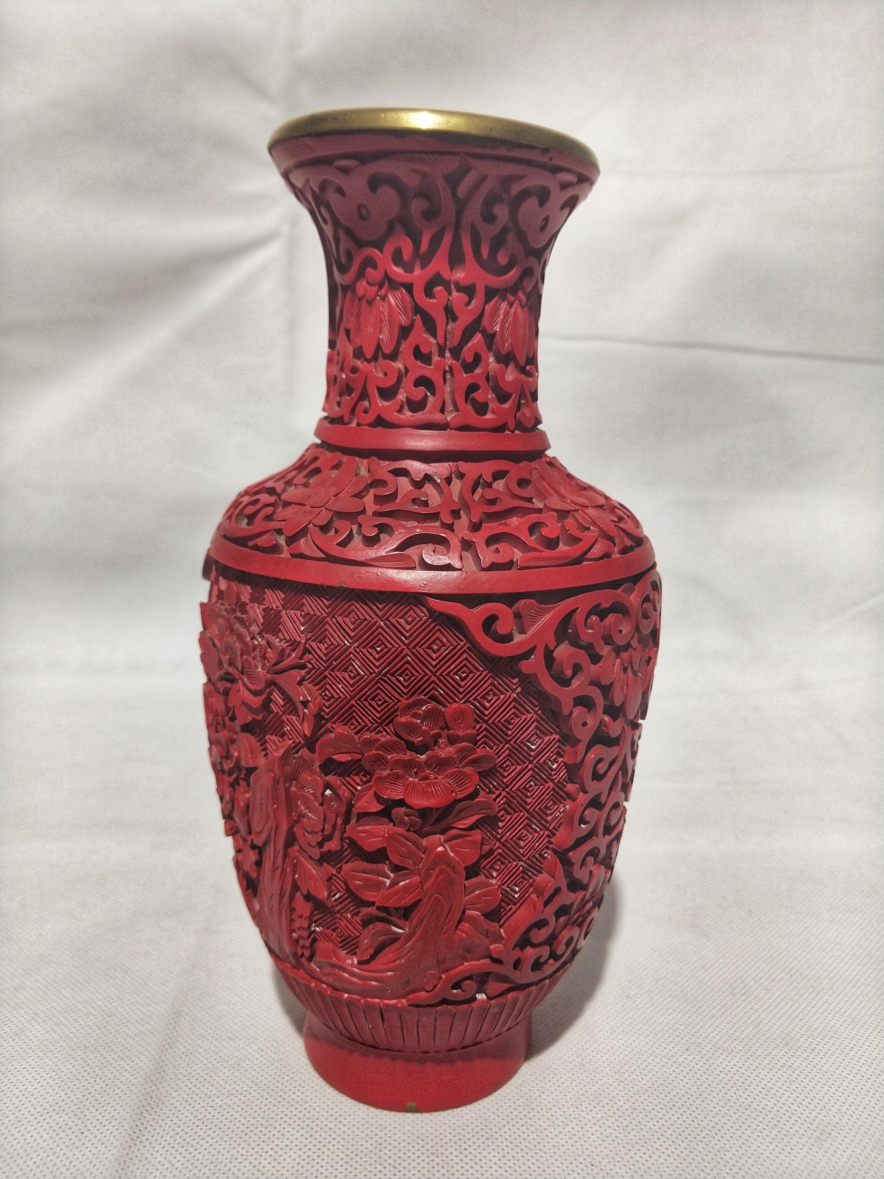 Chinese cinnabar vase carved on brass, with floral motifs, bright red.

Cinnabar and cinnabarite, likely deriving from the Ancient Greek: (kinnabari), refer to the common bright scarlet to brick-red form of mercury(II) sulfide (HgS) that is the