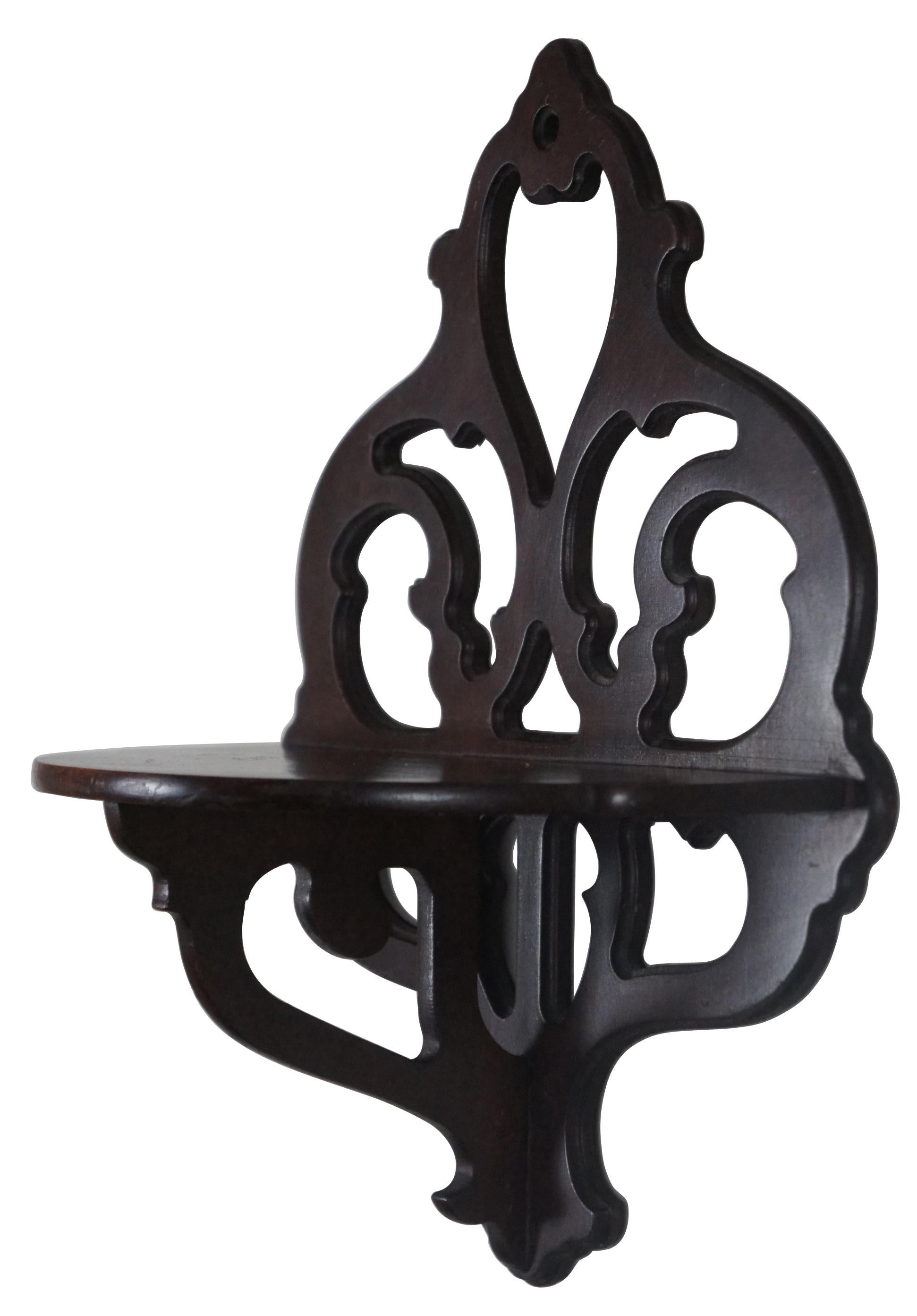 20th century mahogany Chippendale style demilune wall hanging shelf with pierced, carved back.
   
