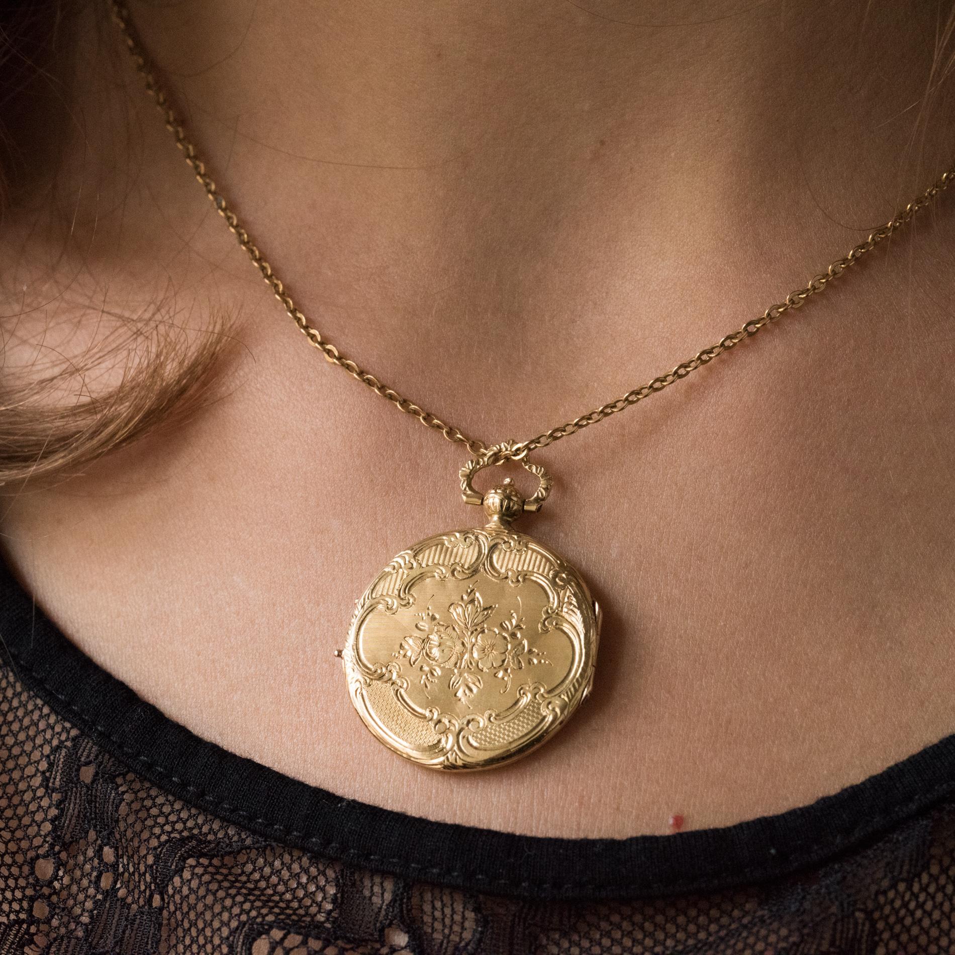 Locket pendant in 18 karat yellow gold, eagle's head hallmark.
Round shape, this antique pendant is engraved on both sides with floral motifs on amati background. The bail is also chiseled. It is opening with a hinge for placing a photo.
Height: 3.8