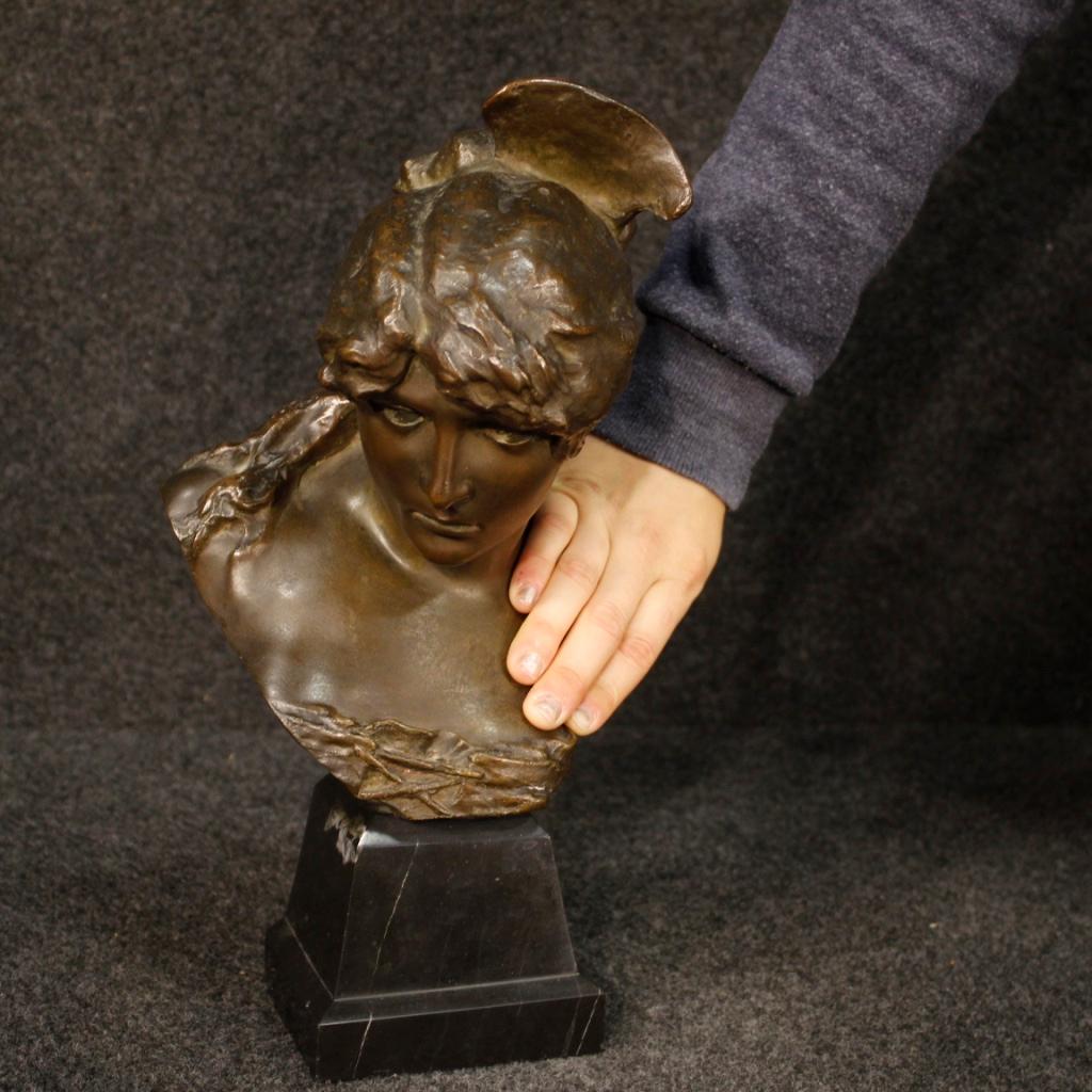 20th century French sculpture. Chiseled bronze work depicting the face of a girl with a marble base. Object of small measures, for antique dealers and collectors, missing signature. Sculpture that presents a restoration intervention on the bronze in
