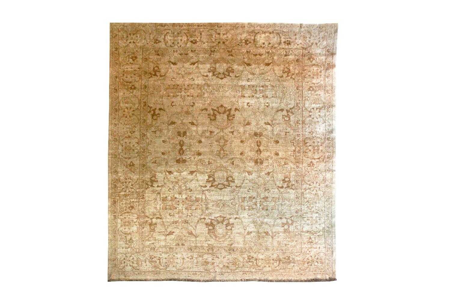 Vintage hand knotted wool rug in a tonal wheat, gold and brown overall pattern. Slightly longer than square, solid wool. Note the rug is photographed from both direction of the weft, to show the light and dark directions of the fibers. Measure: 8 x