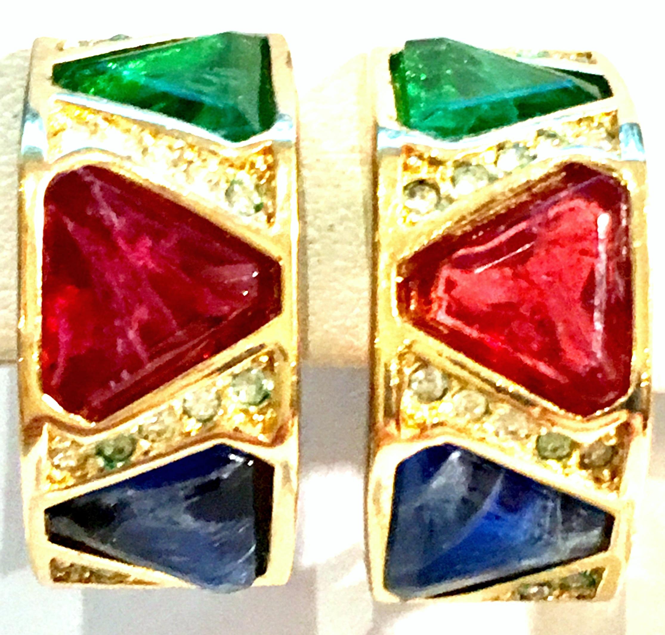 20th Century Pair Of Christian Dior Gold Plate & Austrian Crystal Semi Hoop Earrings.
These finely crafted gold plate semi hoop earrings feature brilliant cut and faceted pave set of blue, green and red with colorless stone accents. These clip style