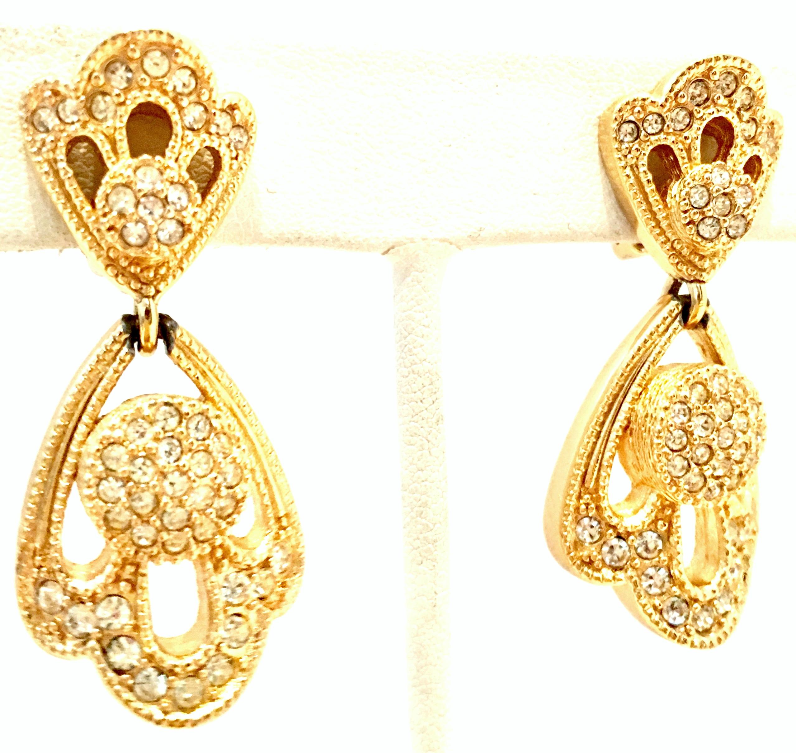 20th Century Christian Dior Pair Of Gold Plate & Austrian Crystal Dimensional Drop Earrings. These finely crafted Christian Dior clip style dangle earrings feature brilliant cut and faceted colorless pave set Austrian crystal stones. Signed on the