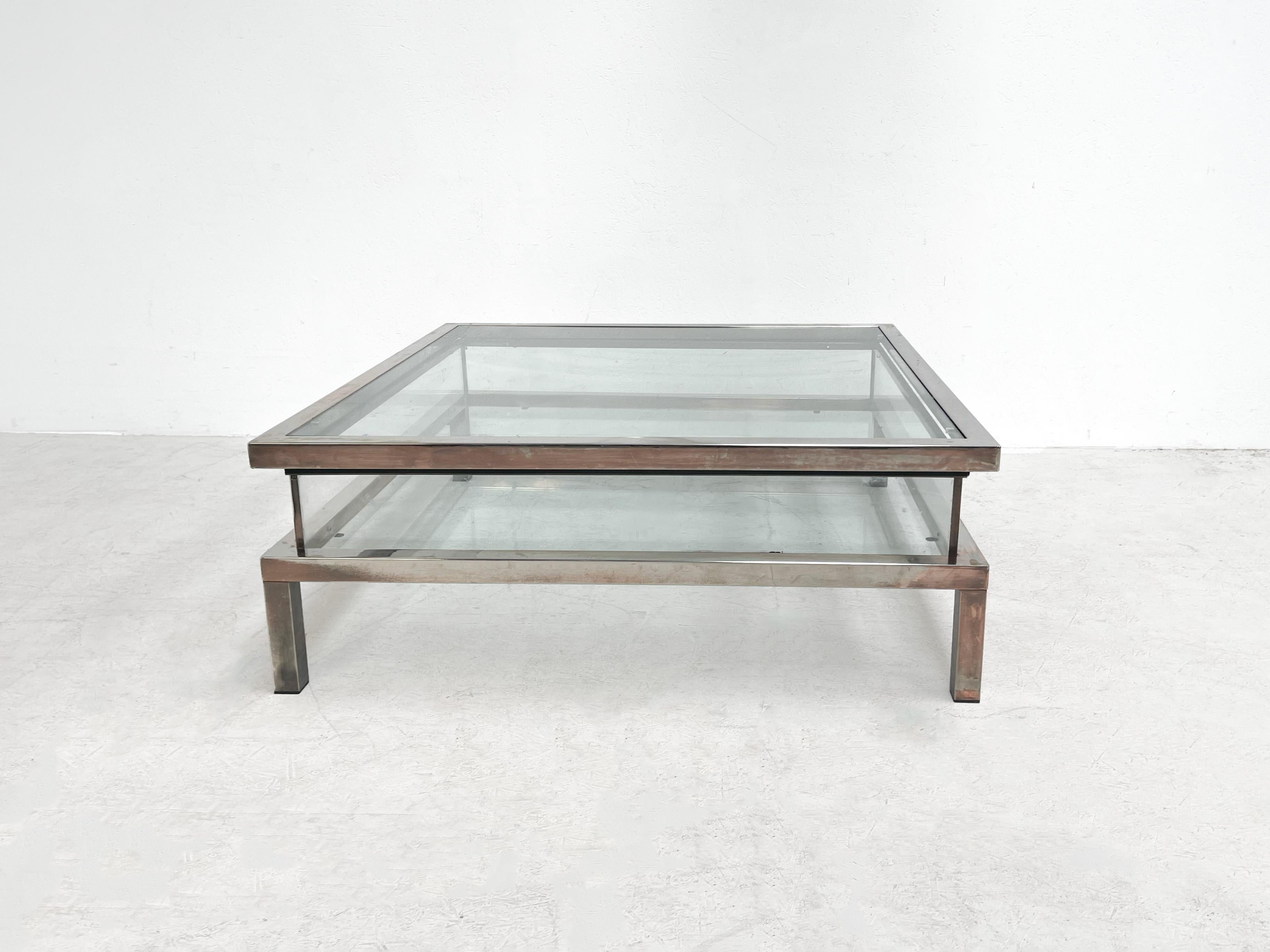 Beautiful sliding coffee table in a Maison Jansen style. The sliding table is perfect to display books, magazines or other fun knick knacks.

 

The table is in ok condtion with signs of age. It has oxidation on the frame and some scratches. The