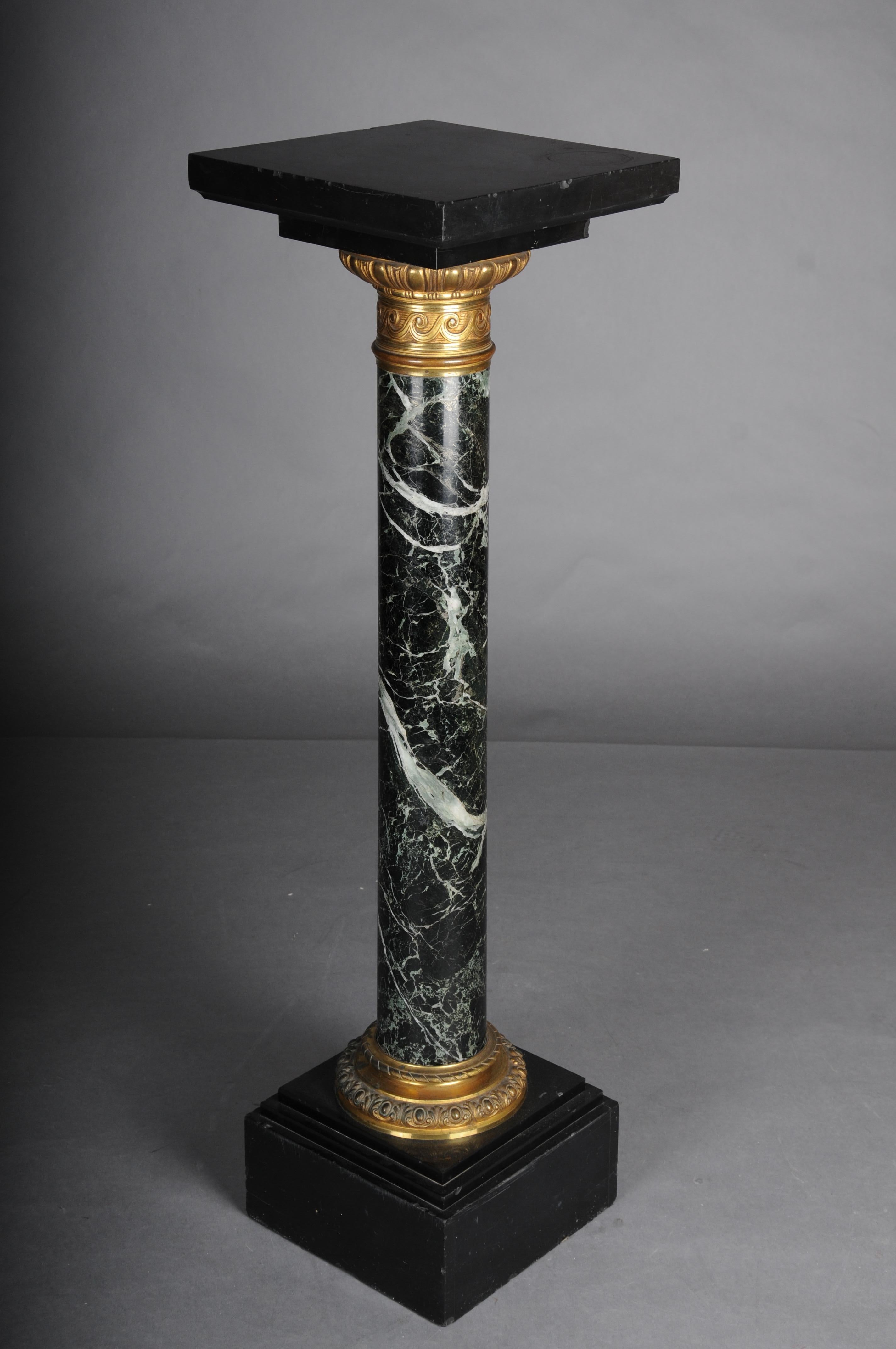 19th Century Classic French marble column, black with gold brass.

Impressive marble column, column shaft in black, white, and green mottled. Black square base and top.

Finished with gold brass appliqués. Please refer to the detailed photos for the