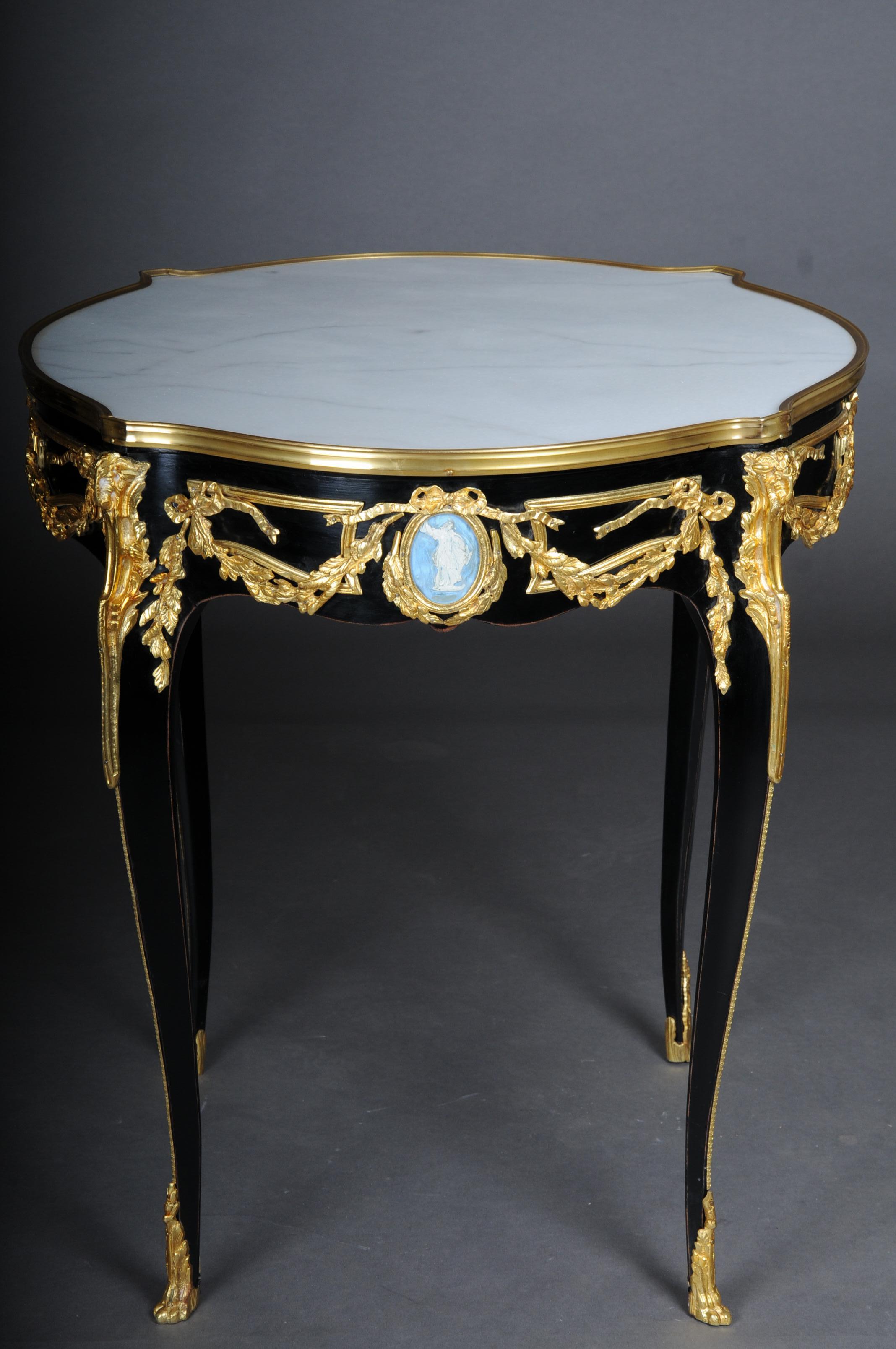 20th Century Classic side table, gilt bronze, black, Louis XV

Solid beech body, blackened with rich brass bronze decorations, gilded. Round white marble top with gilt frame. The marble top has a stunning mottle. Each frame stripe centers a