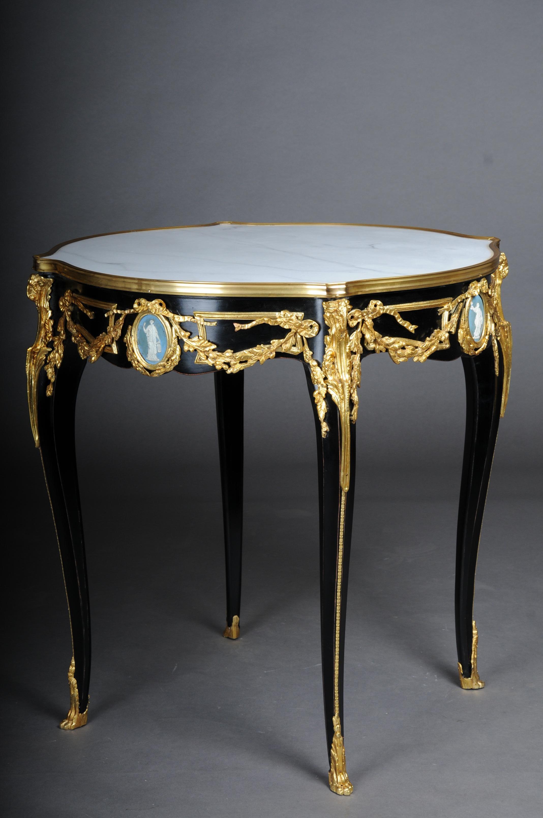 20th Century Classic side table, gilt bronze, black, Louis XV

Solid beech body, blackened with rich brass bronze decorations, gilded. Round white marble top with gilt frame. The marble top has a stunning mottle. Each frame stripe centers a