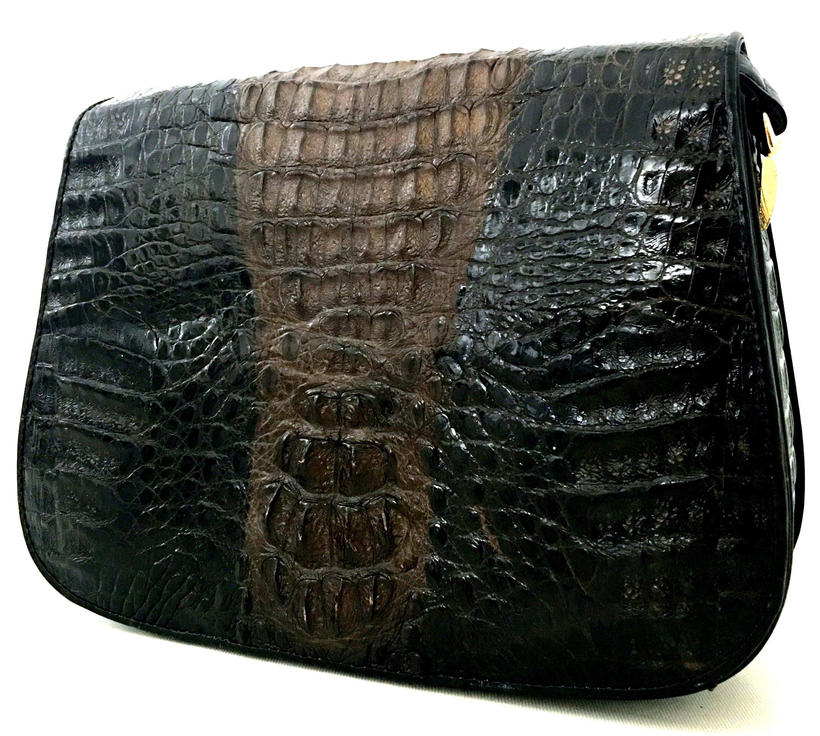 20th Century Classic Two-Tone Black & Brown Authentic Crocodile Skin Handbag.This multi-use hand bag, features gold gilt brass hardware, invisible front snap closure ,three interior storage pockets and adjustable shoulder strap. This multi - purpose