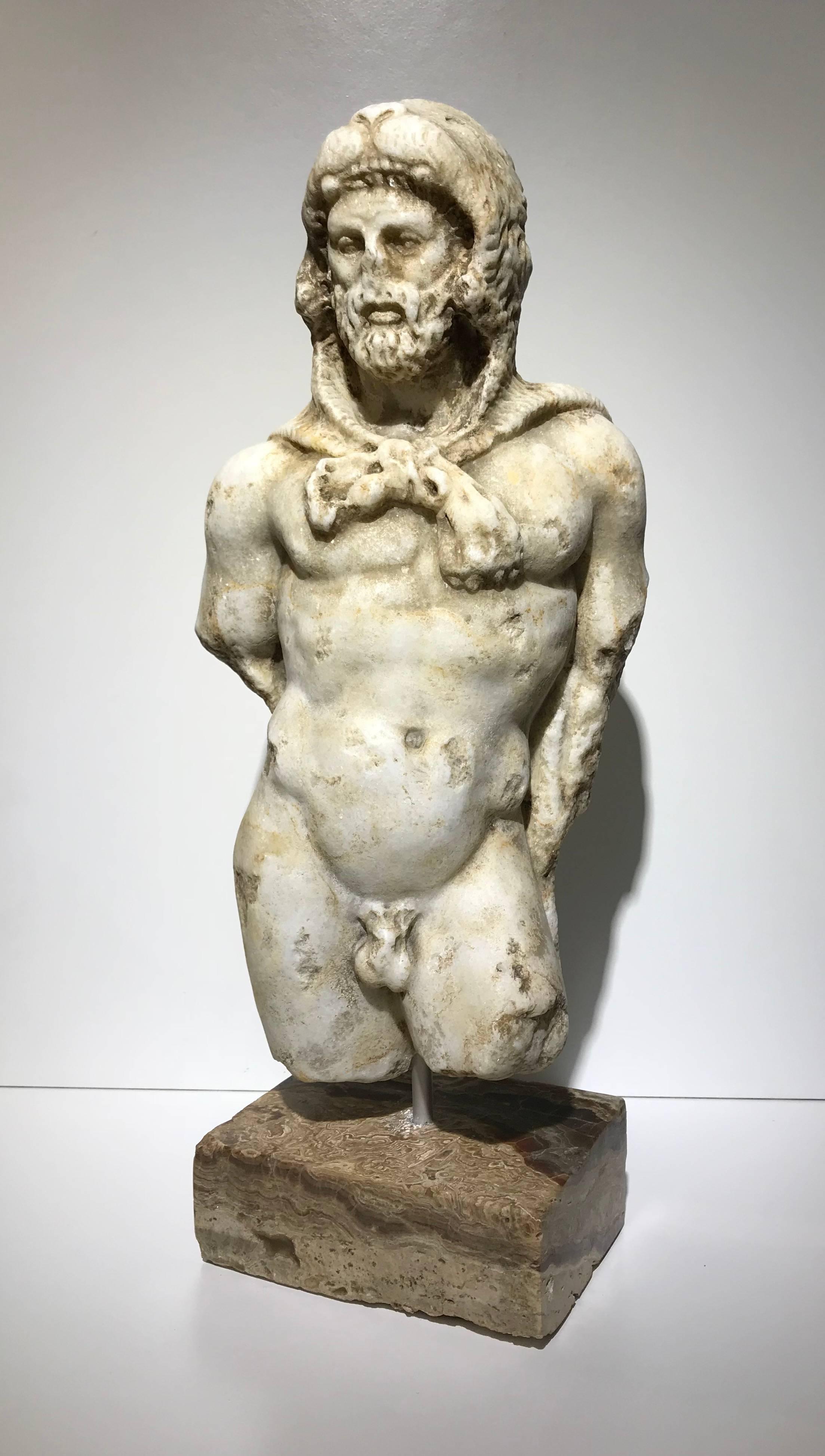 Here, the Roman Emperor has taken on the guise of the mythological hero, Hercules. He has been given the attributes of the hero: the lion skin placed over his head, the club placed in his right hand, and the golden apples of Hesperides in his left.