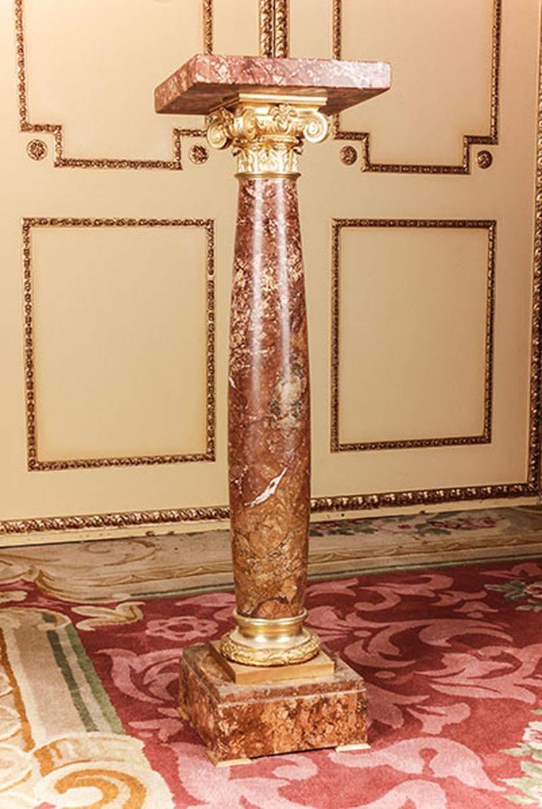 Unique marble ornamental pillar in Classicist style.
Bordeau red marble with grey white\flecking square plinth with balustrade-formed column base with carved Acanthius capping. The highly valuable bronze fixtures are prominent and of superb