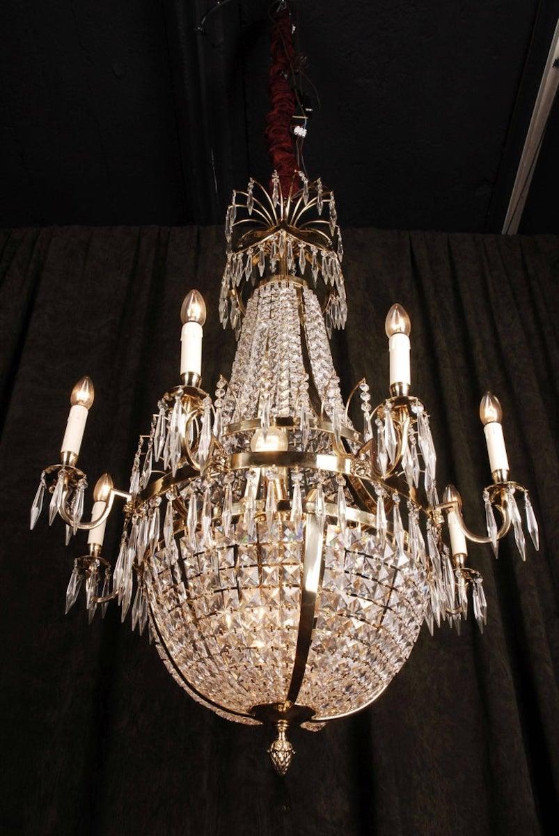 Swedish Empire ceiling candelabra in classicist style.
Polished brass and facett-ground prism hangings.
