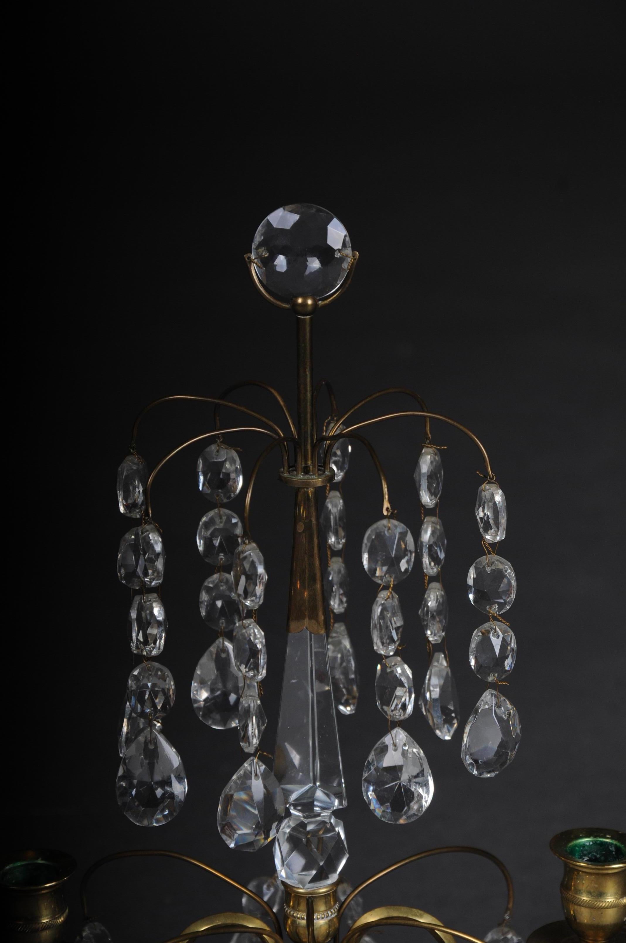 20th century classicist Swedish Empire Girandole/candlestick, circa 1900

Crystal hanging with marble base and brass mount.
Brass connected by facetted hand-wired, prisms cords in the course. Over a square white marble plinth, baluster shaft as a