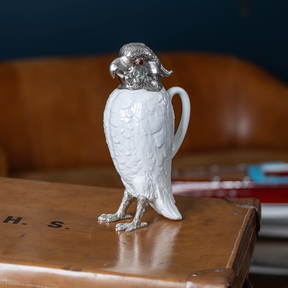 Antique early-20th Century English solid silver and mounted on Spode Copeland's China novelty wine jug, in the form of a standing cockatoo, set with coloured glass eyes and white porcelain body imitating textured plumage, mounted with a
