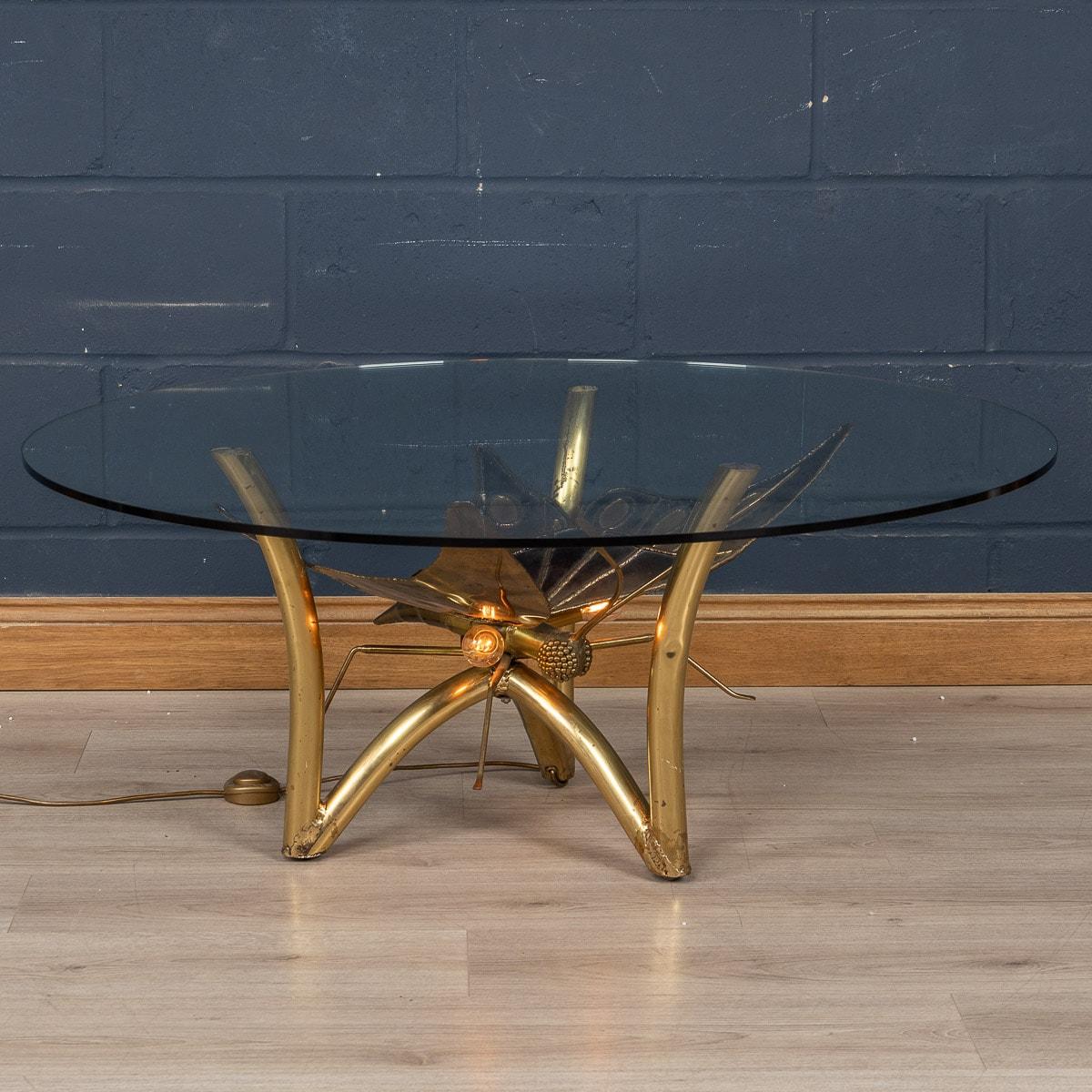 A lovely Maison Jansen side table or coffee table, 1970s, with two light points under a circular clear glass. The centre has a beautifully crafted butterfly and when the table it illuminated it creates a wonderful warm glow from any angle. Of lovely