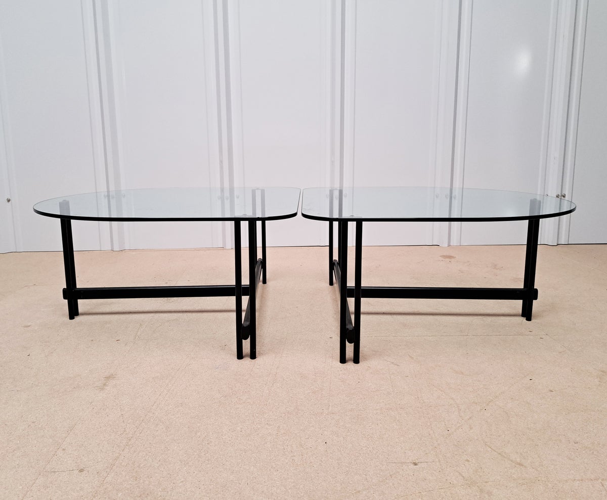 Late 20th-Century coffee table. This coffee table can be as one, or separated into two sections! these can also be used on either side of a sofa or as side tables. The glass sits on a metal structure, an elegant and fun piece. 