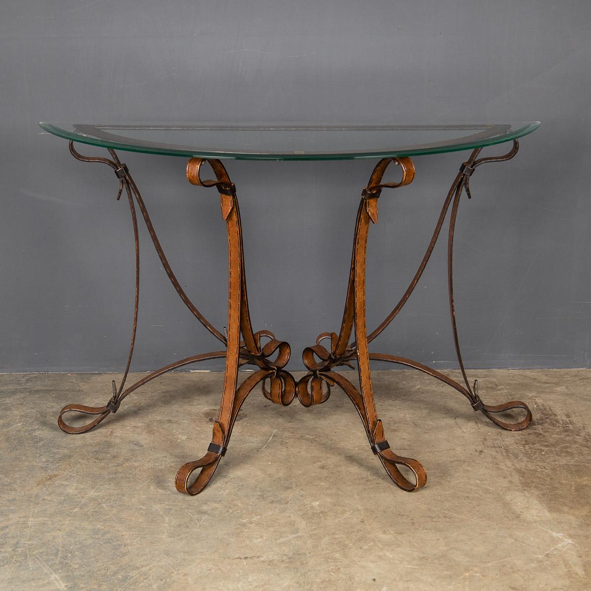 A sturdy cold painted wrought iron console, with stitched strap and buckle detail and a bevelled glass top, made in the 1980's.

Condition
In Good Condition - wear consistent with age.

Size
body only:
Width: 98cm
Depth: 34cm
Height: