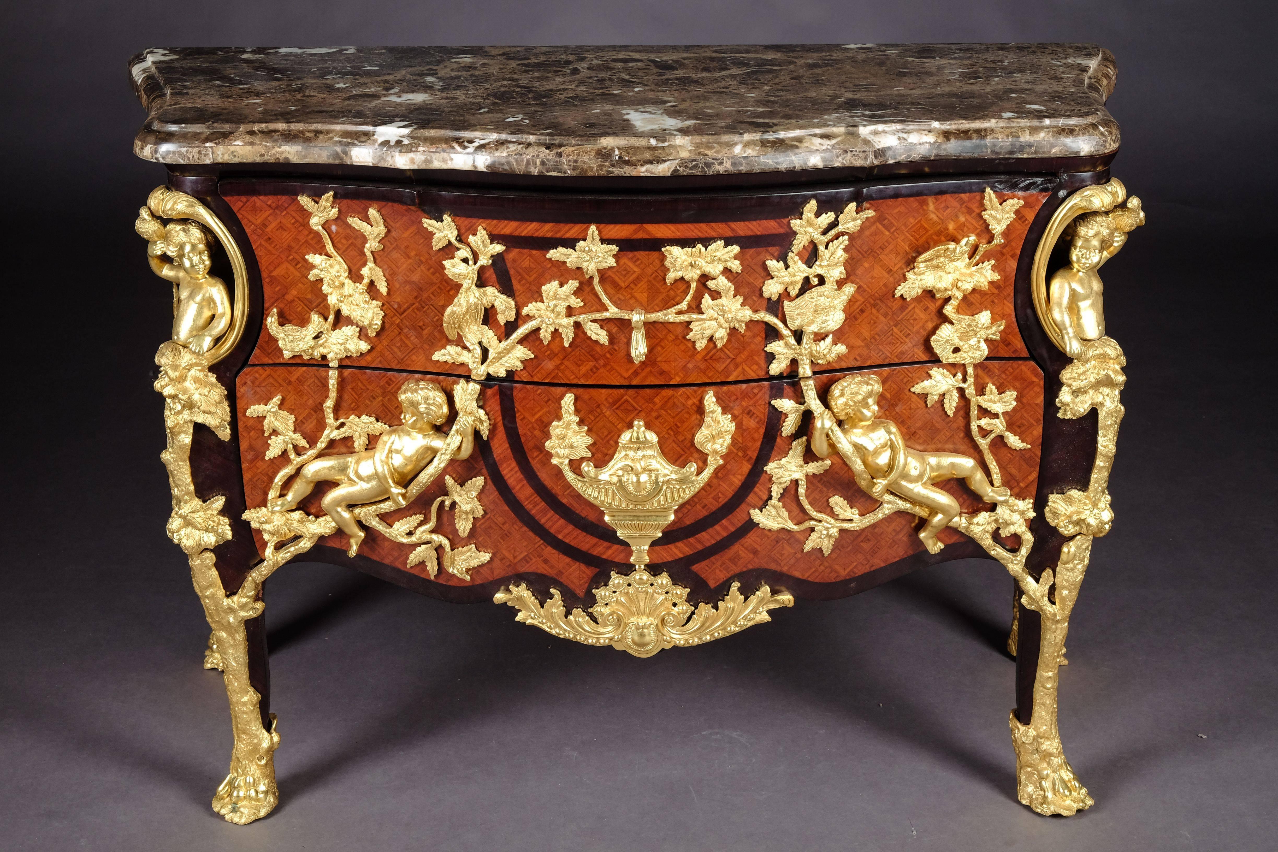 Majestic Commode by model Charles Cressent, 1685-1768, Paris.
 inlaid filling in the form of rhombuses of different precious woods, limited by so-called mirror veneer. On all sides, the cambered body on a deeply draped frame, ending over high loops