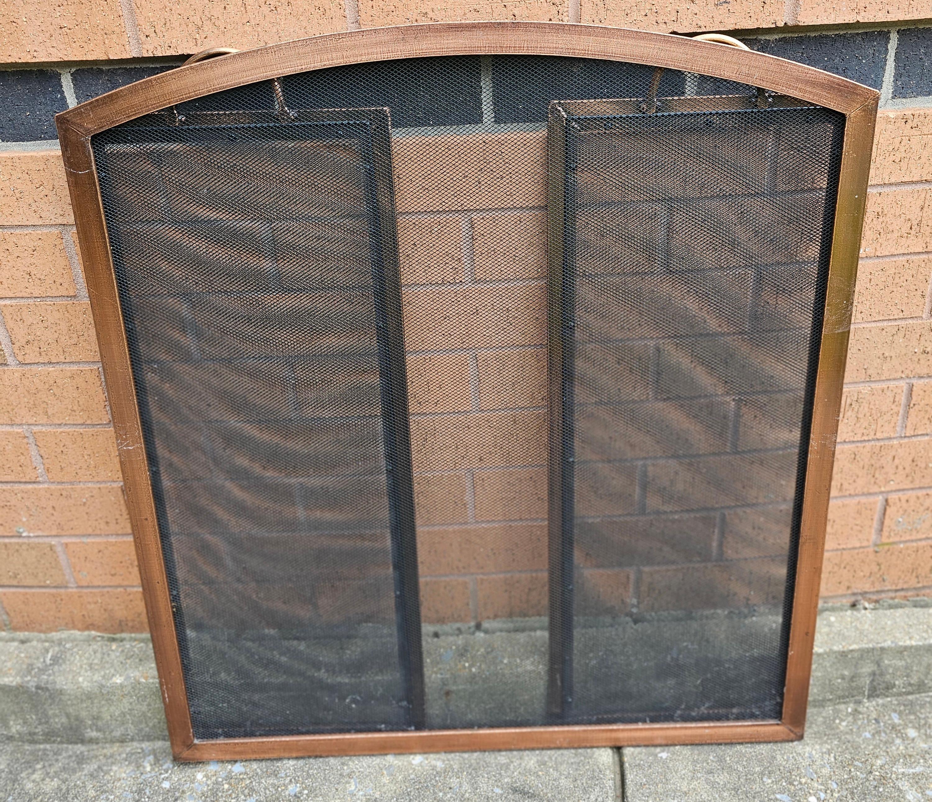 A 20th Century Copper and wire mesh Trifold Fireplace Screen. Patinated Antique copper finishand Steel construction
Comes with Large 3-panel design to accommodate larger fireplaces and Integrated handles make tending fires easy.
Measures 54
