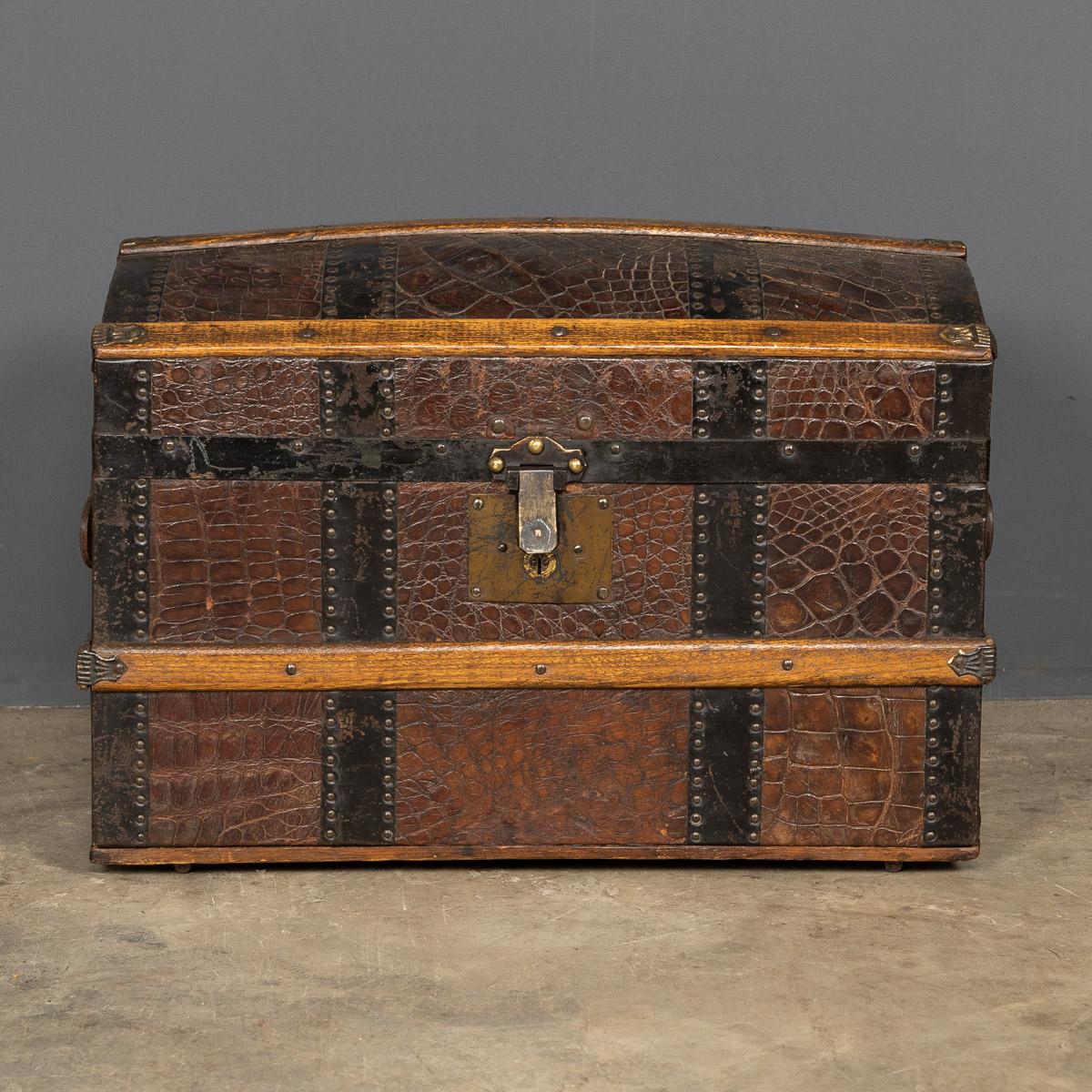 Antique early-20th century steel bound, crocodile covered travelling trunk for a child, these trunks were also used to store childrens clothes. This piece has its original wooden interior and lock with key.

Condition
In great condition - wear as