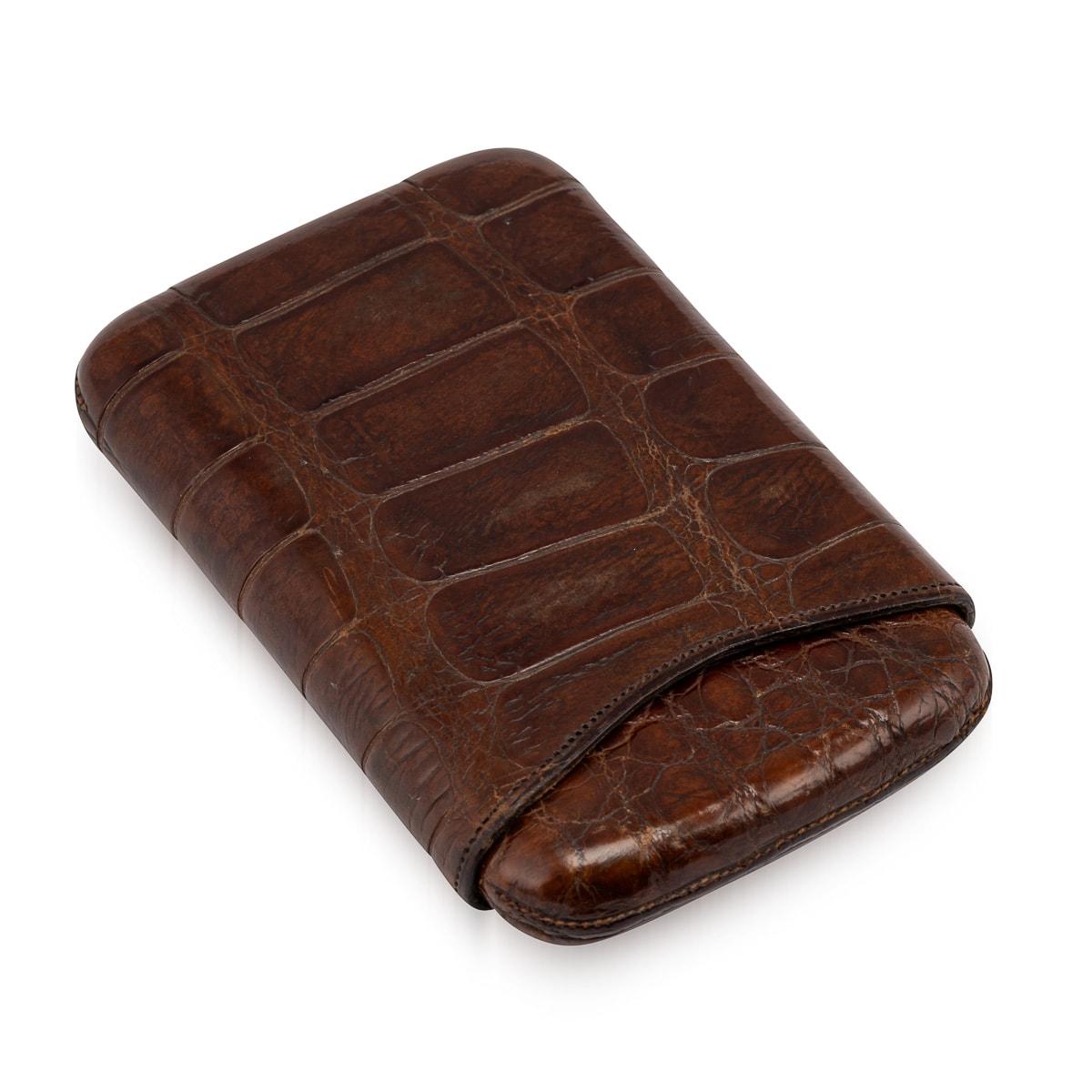 A crocodile skin cigar case of exceptional quality, meticulously crafted in England during the early part of the 20th century, around 1910/20. Exhibiting a timeless design, this wonderful cigar case adheres to the typical form with an inner sleeve.