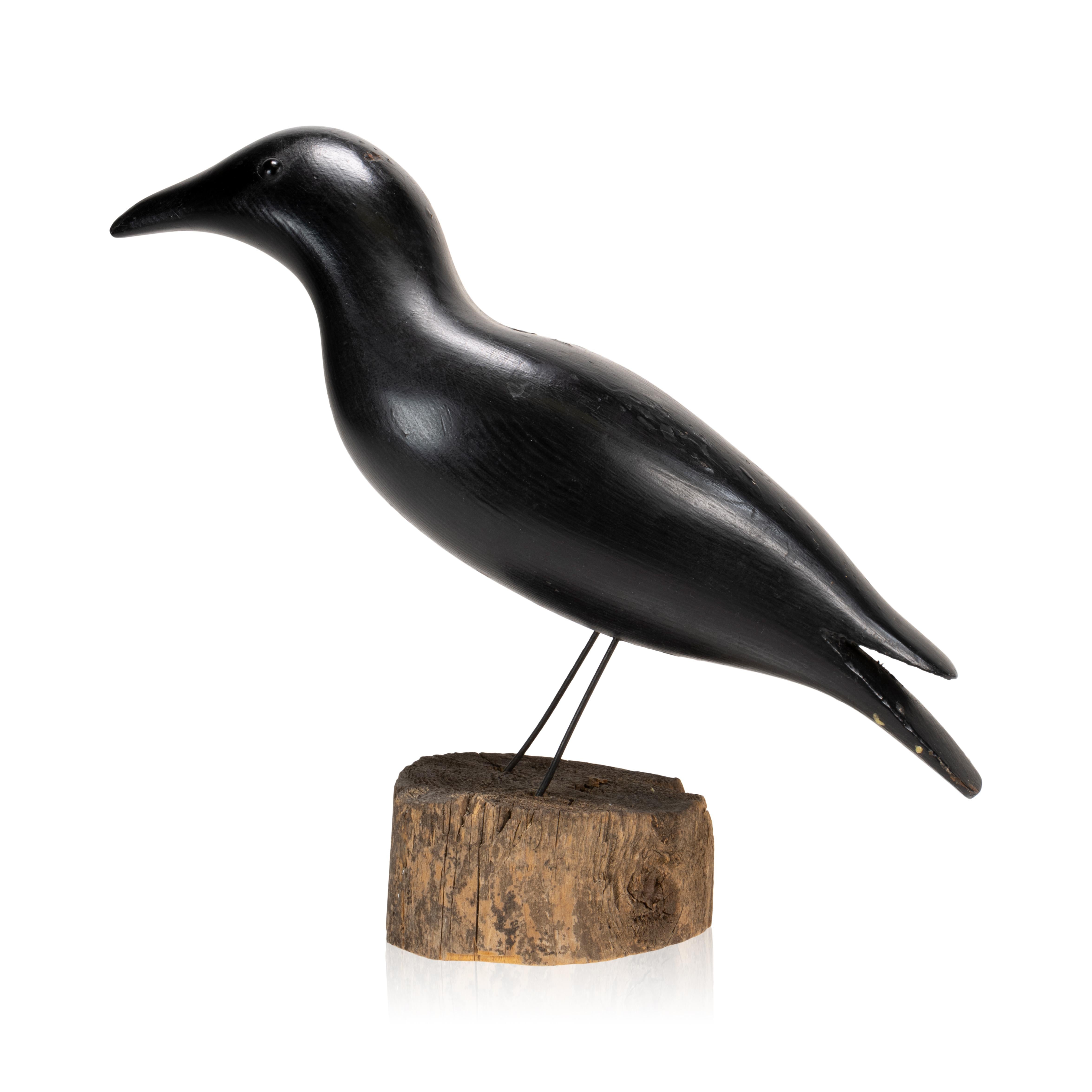 Early 20th Century crow decoy. Carved and painted decoy on wood base. Glass eyes. Initials on bottom 