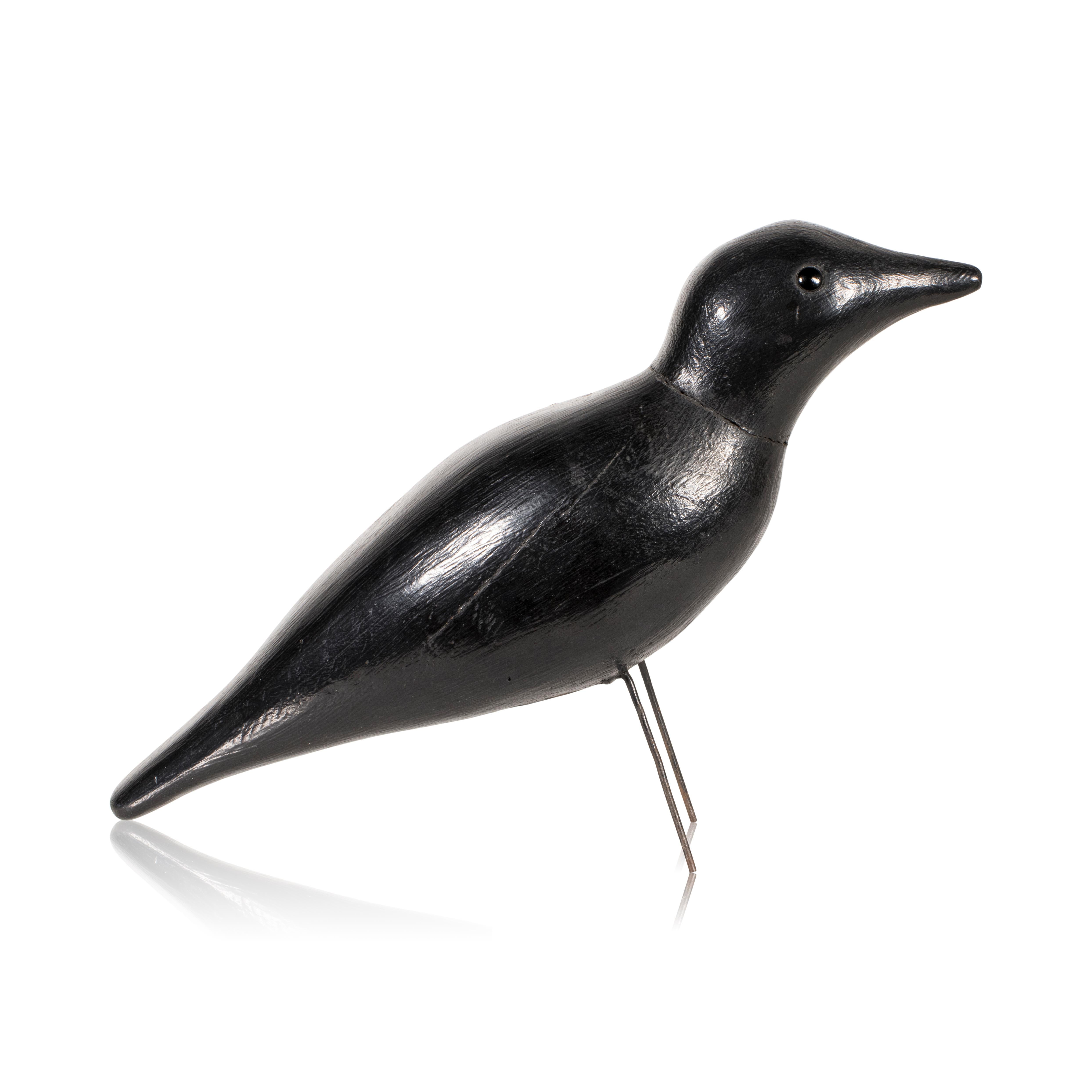 Early 20th Century carved and painted crow decoy with glass eyes and wire legs.

Period: Early 20th century
Origin: United States
Size: 10