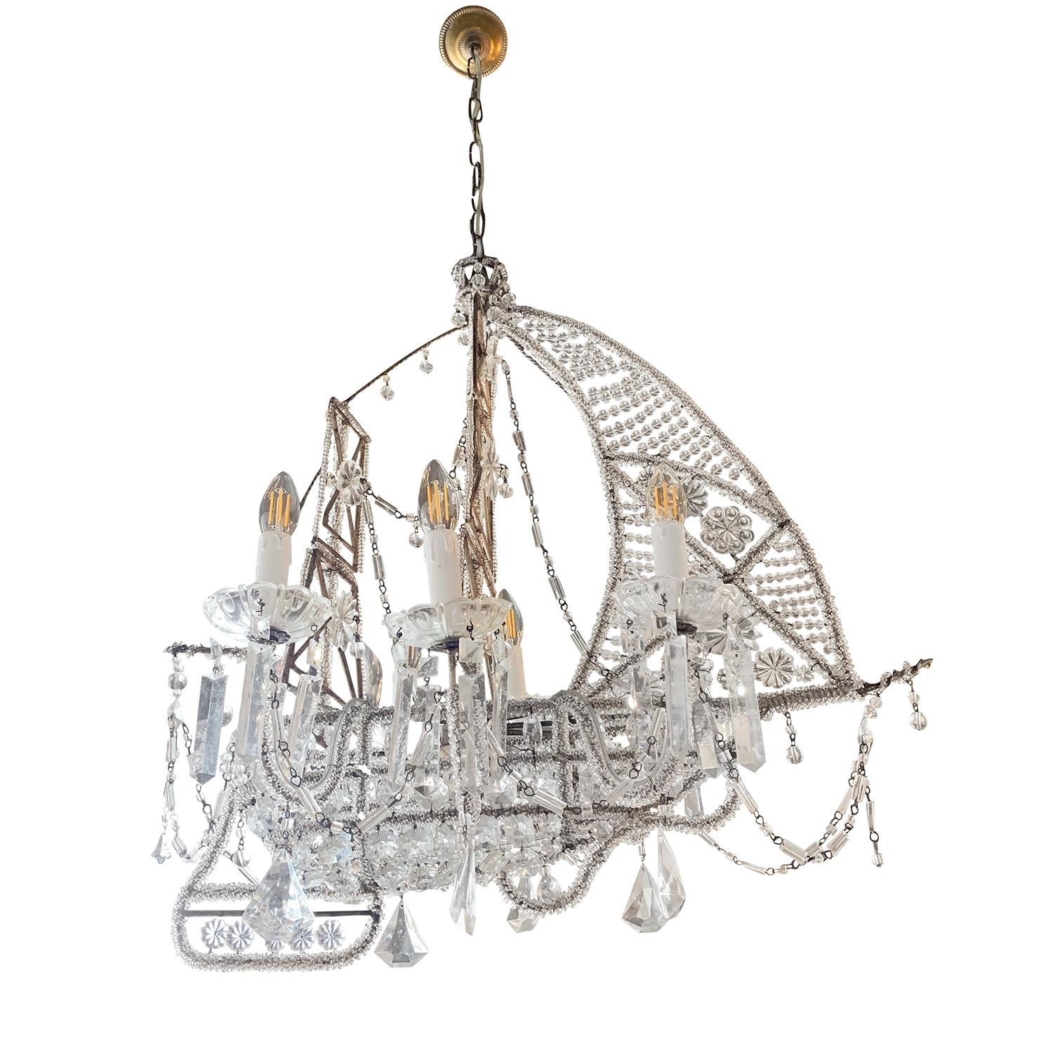 This French Art Deco chandelier is in the shape of a ship with wrapped crystal beads and studded in crystal flowers. The vintage pendant is in good condition. It holds six-light with long crystals draped from each arm. Wear consistent with age and
