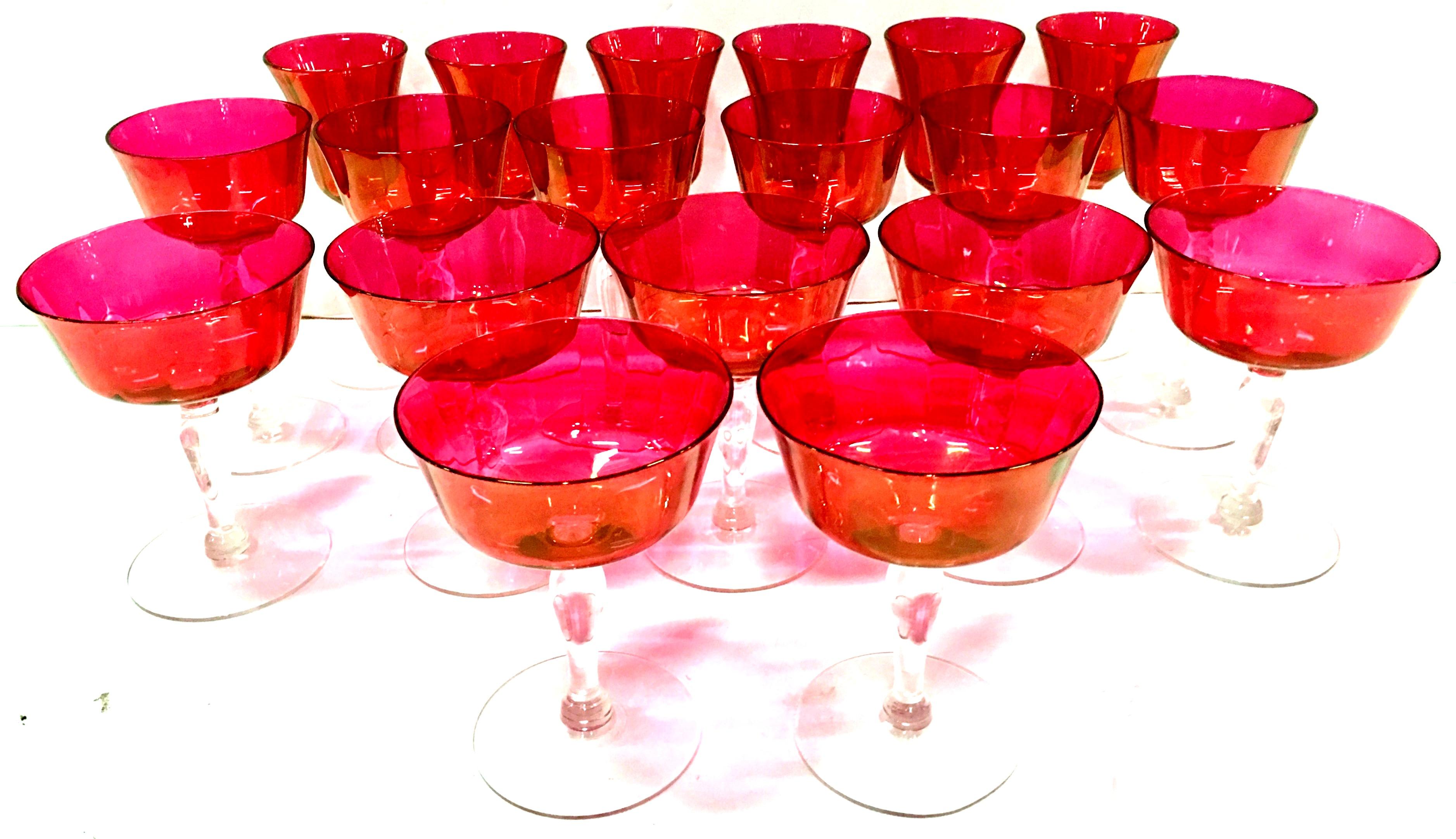 1960'S Set Of 19 Crystal optic and iridescent cranberry and clear footed stem drink glasses. Set includes three sizes, seven large coupe glasses, six coupe glasses and six sherry glasses
Measure: Coupe glass 5.75