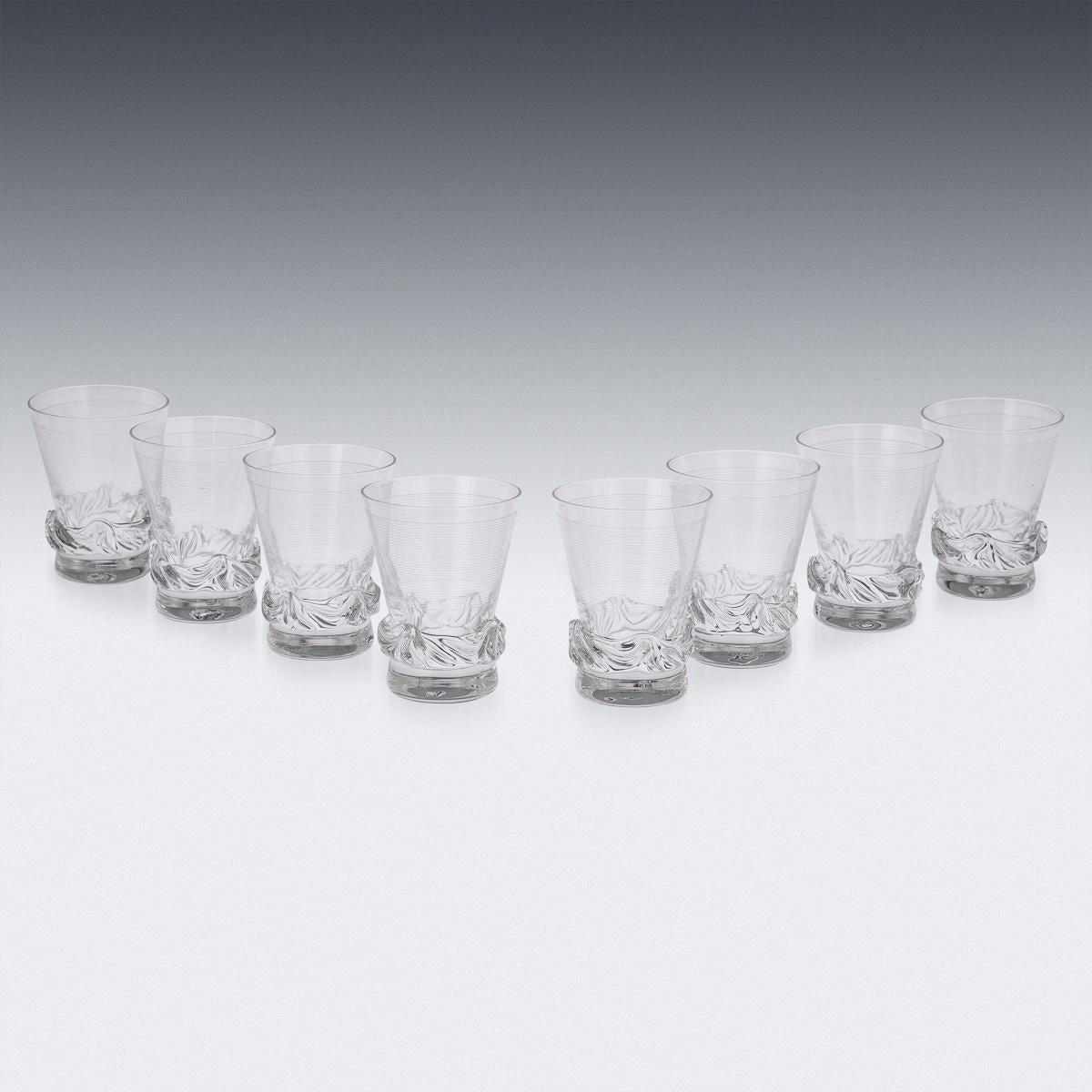 A set of eight sculptural crystal tumblers. Made around the middle of the 20th century, this refined translucent glass pattern was realised by the fabled French design house Daum. With its timeless form and clean modernist lines, these items are as