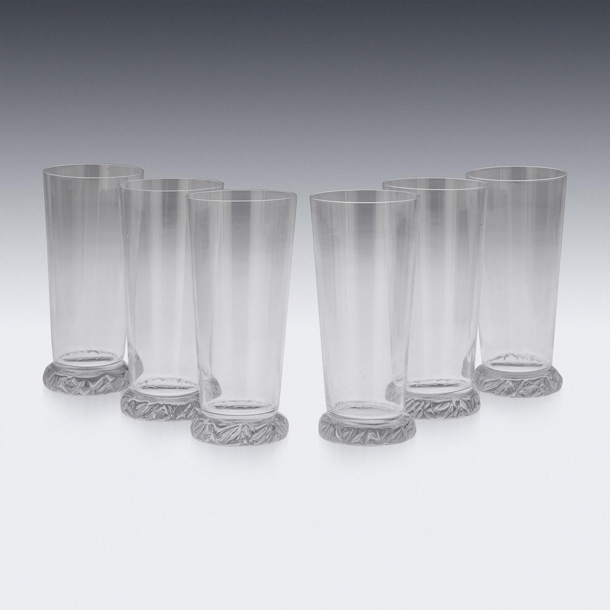 A set of six sculptural crystal lemonade or cocktail tumblers. Made around the middle of the 20th century, this refined translucent glass pattern was realised by the fabled French design house Daum. With its timeless form and clean modernist lines,