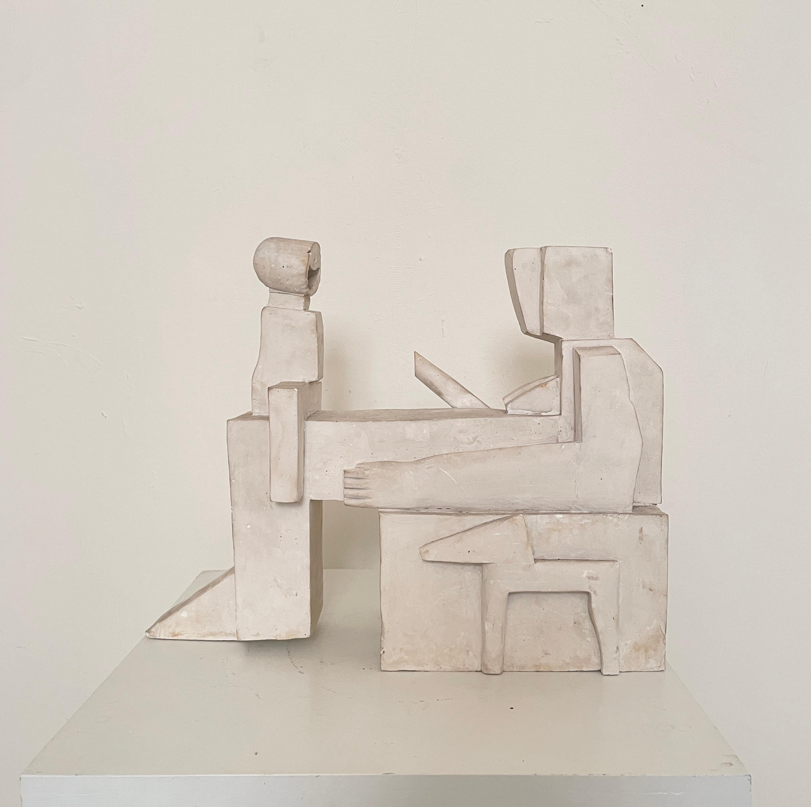 This fancy cubist sculpture made of plaster was made in the 1960s. 
It shows a mother who has her child on her lap and plays with him 