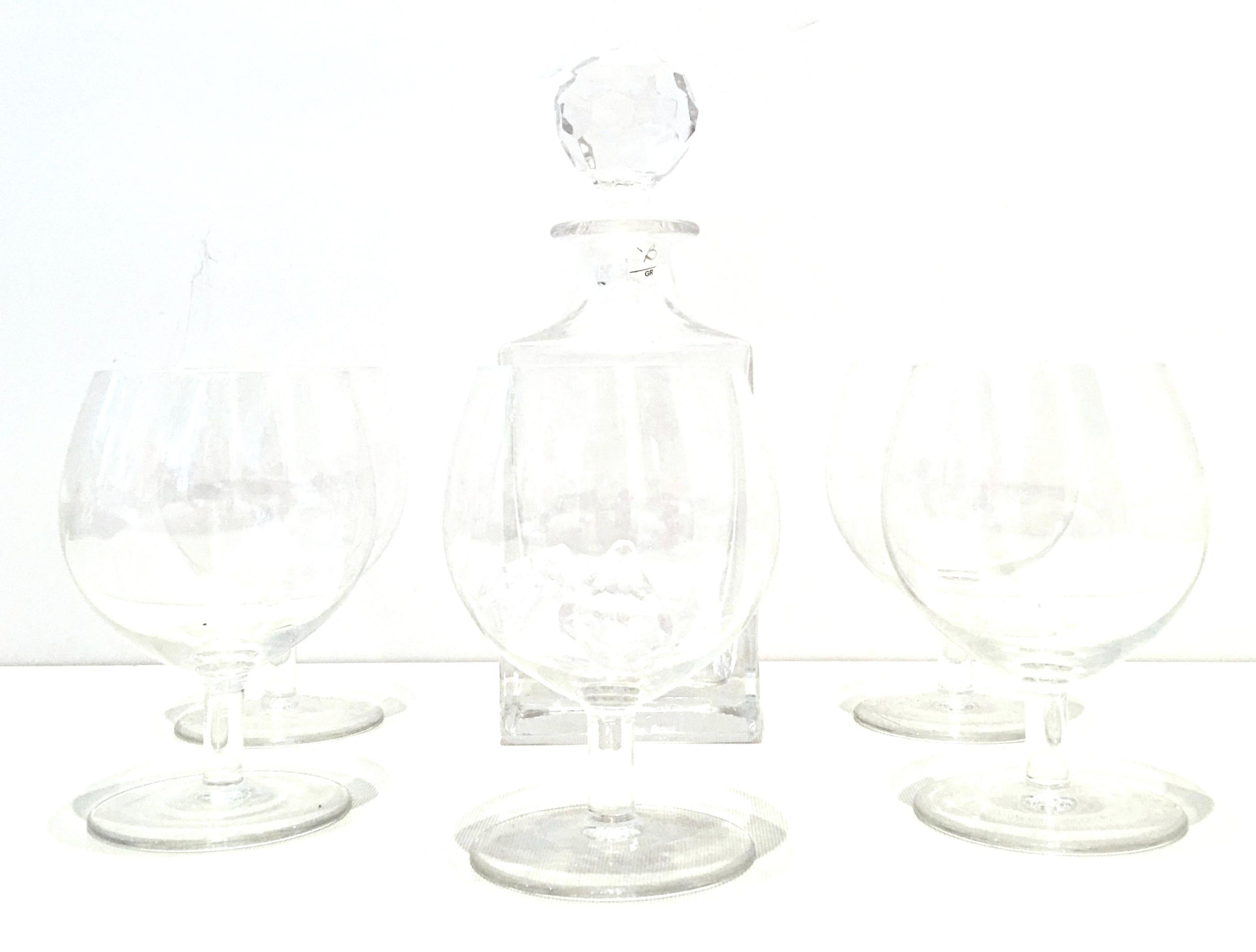 20th century cut crystal liquor decanter and crystal stem drink glasses by, Tiffany & Co. and Riedel. This six-piece set includes one Tiffany & Co. liquor decanter with stopper and five crystal stem drink glasses by, Riedel. Each piece is