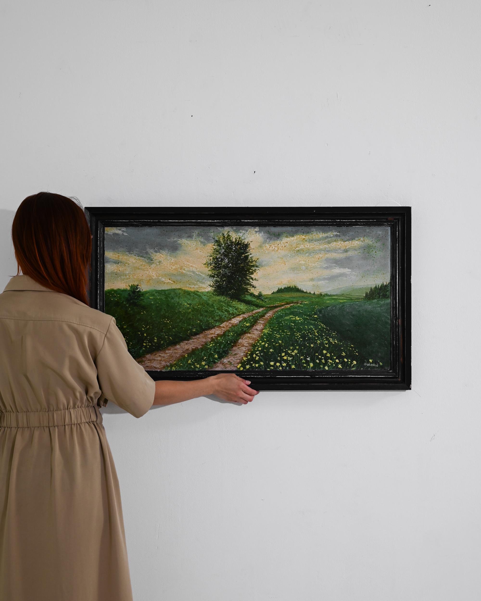 This 20th-century Czech artwork encapsulates the serene beauty of the pastoral landscape within its wooden frame. The painting invites viewers to wander down the winding path, flanked by lush meadows and dotted with wildflowers that seem to sway