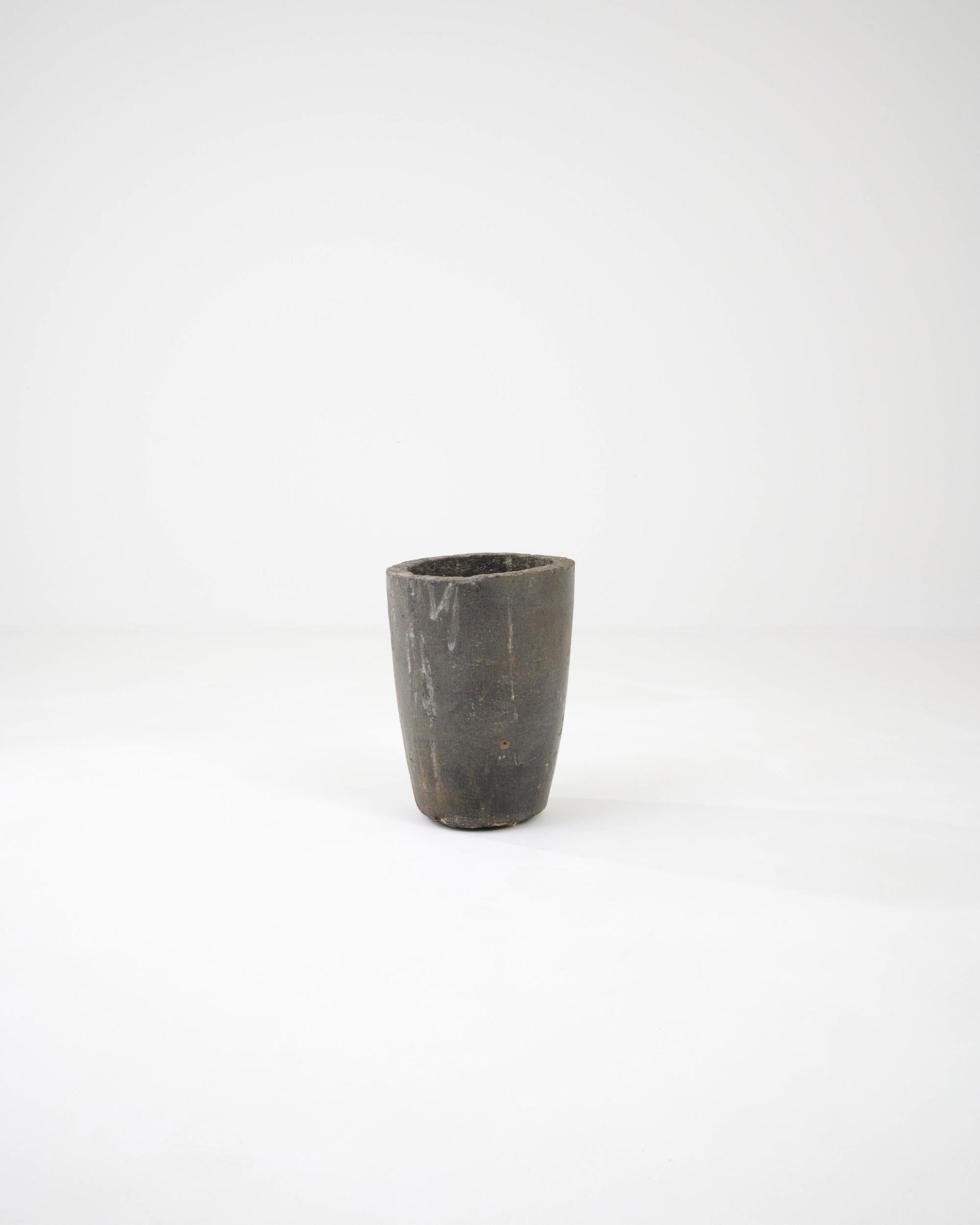 Crudely minimalist, this Czech concrete planter epitomizes solid brutalist aesthetics. Its uneven edges accentuate the rawness of the naked gray concrete that will imbue your space with a stylish industrial touch.