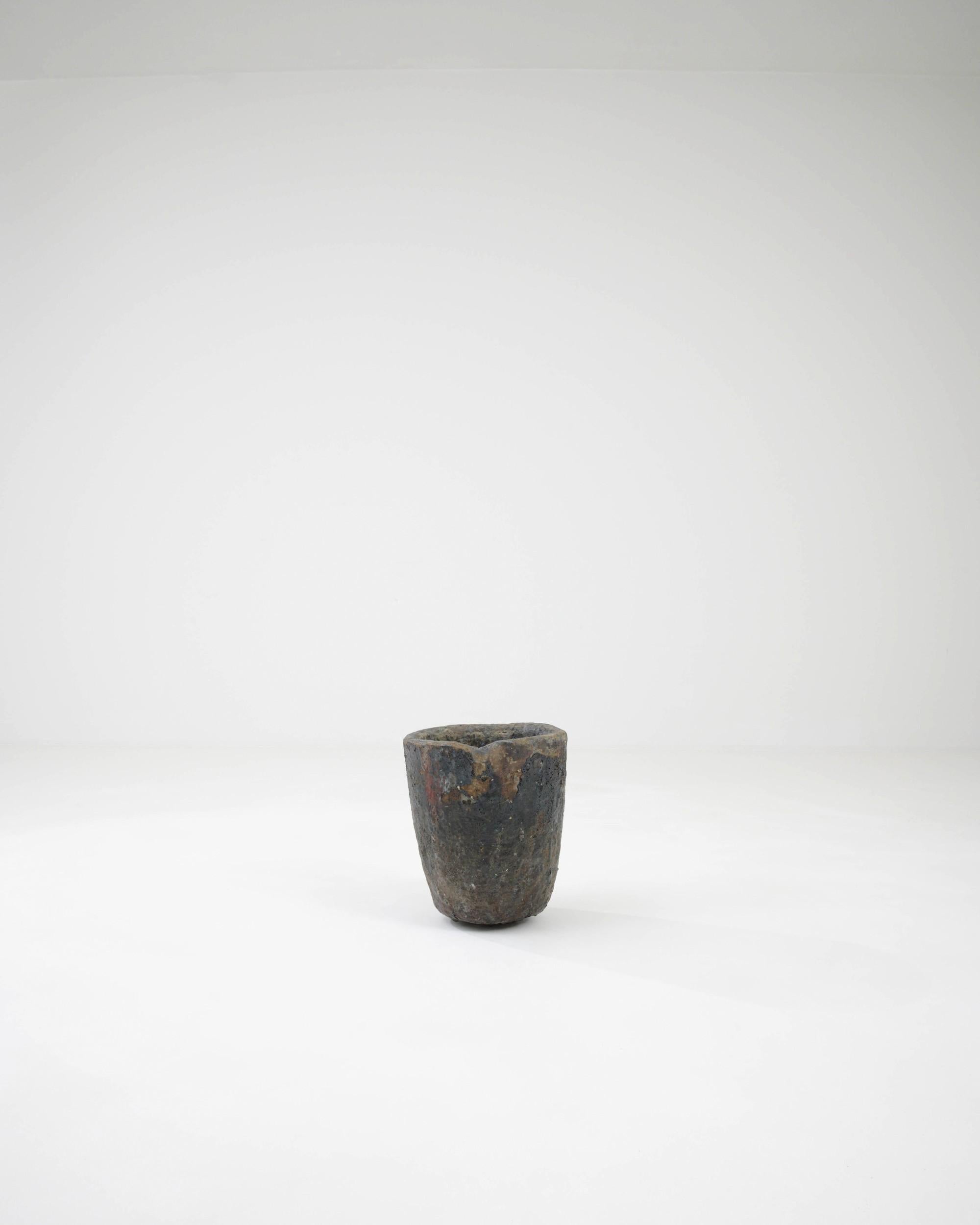 Simple, sculptural and supremely tactile, this vintage foundry crucible has an ardent Industrial past. Made in 20th century Czechia, this piece would have originally been used for melting metals in a furnace. Pits and craters mark the surface of the