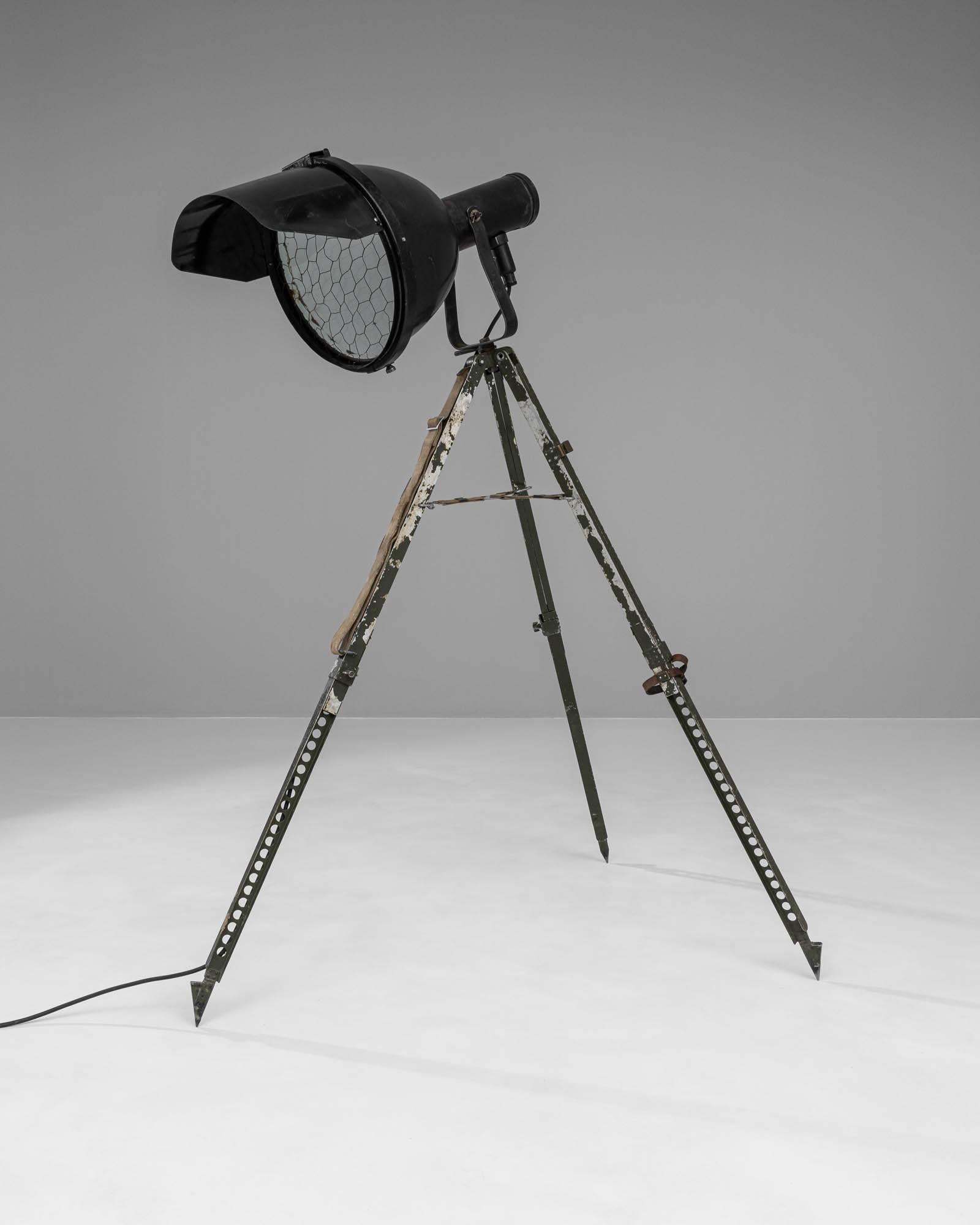 Step into the spotlight with this striking 20th Century Czech Metal Floor Lamp, a stellar fusion of form and function. Crafted during a time when durability met design, this floor lamp boasts a robust, military-green tripod base that carries the