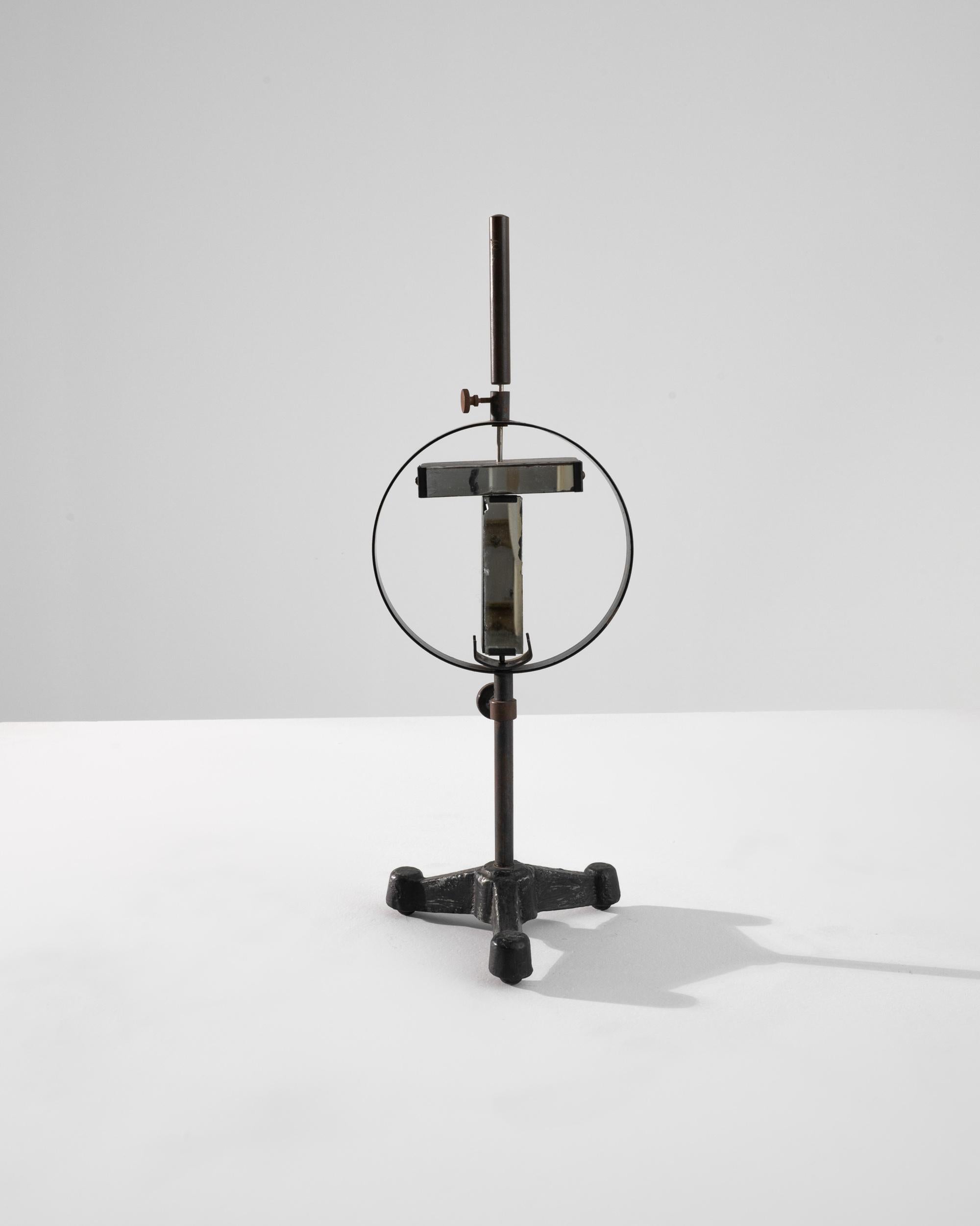 A metal decoration from 20th century Czechia. A cast base, along with metal tubes, bands, and adjustable bolts creates the image of a scientific object, whose purpose remains opaque. Characteristic of 20th century Czechian sensibilities, this