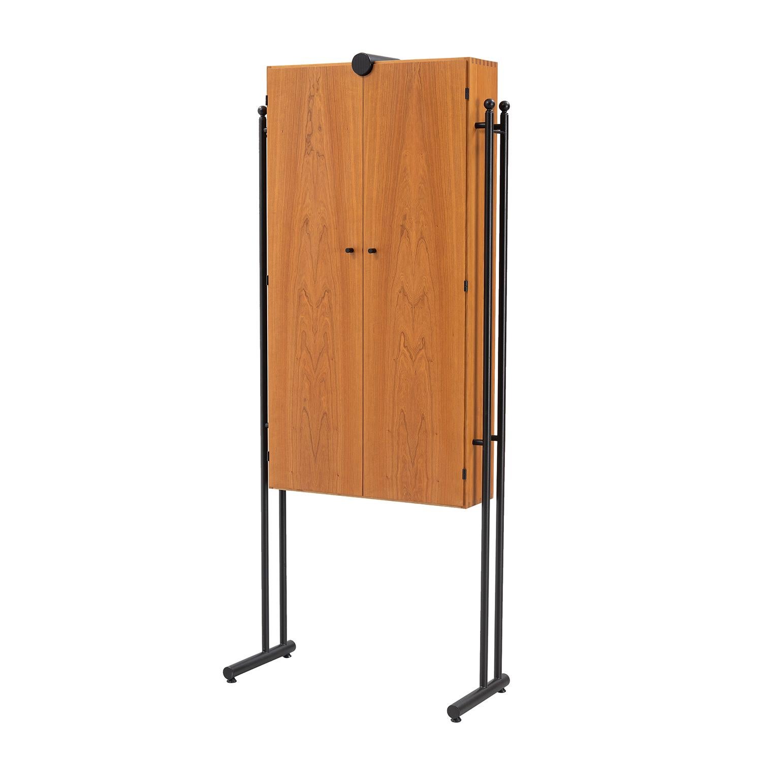 A light-brown, vintage Mid-Cenutry modern Danish wardrobe, armoire made of hand crafted polished Walnut designed by Hadsten Träindustri and produced by Akuma, in good condition. The slim buffet is composed with two doors, particularized by two round