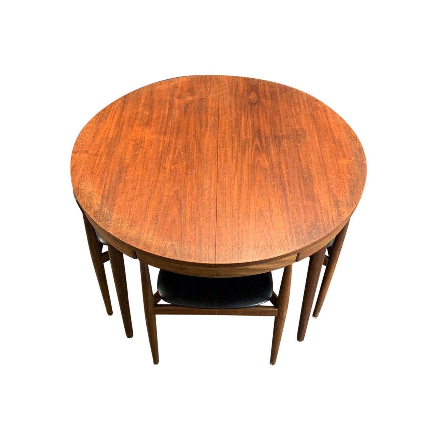 A vintage Mid-Century Modern Danish roundette dining table made of hand carved teakwood, designed by Hans Olsen and produced by Frem Røjle, in good condition. The round, Scandinavian dining table is extendable, composed with four chairs which fully