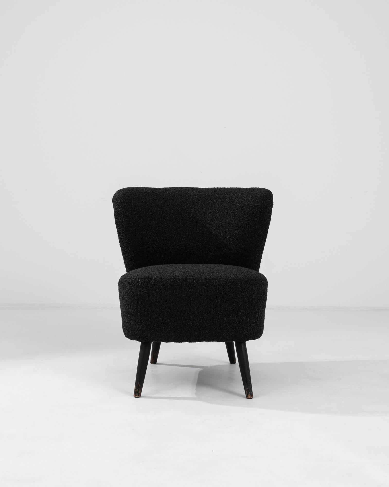 Introducing the 20th Century Danish Upholstered Chair, a fusion of minimalist design and comfort that brings a touch of Scandinavian sophistication to any room. This mid-century modern gem features a sleek, organic wooden frame complemented by a