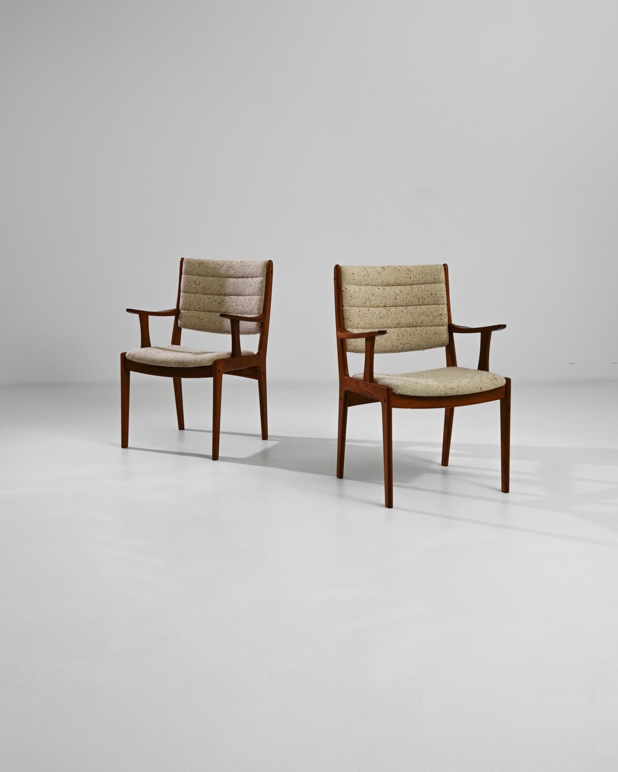 Enhance your home with the sophisticated charm of this pair of 20th Century Danish Wooden Armchairs. Exuding the timeless elegance of Scandinavian design, these chairs feature beautifully crafted wooden frames with a warm, rich finish. The contoured