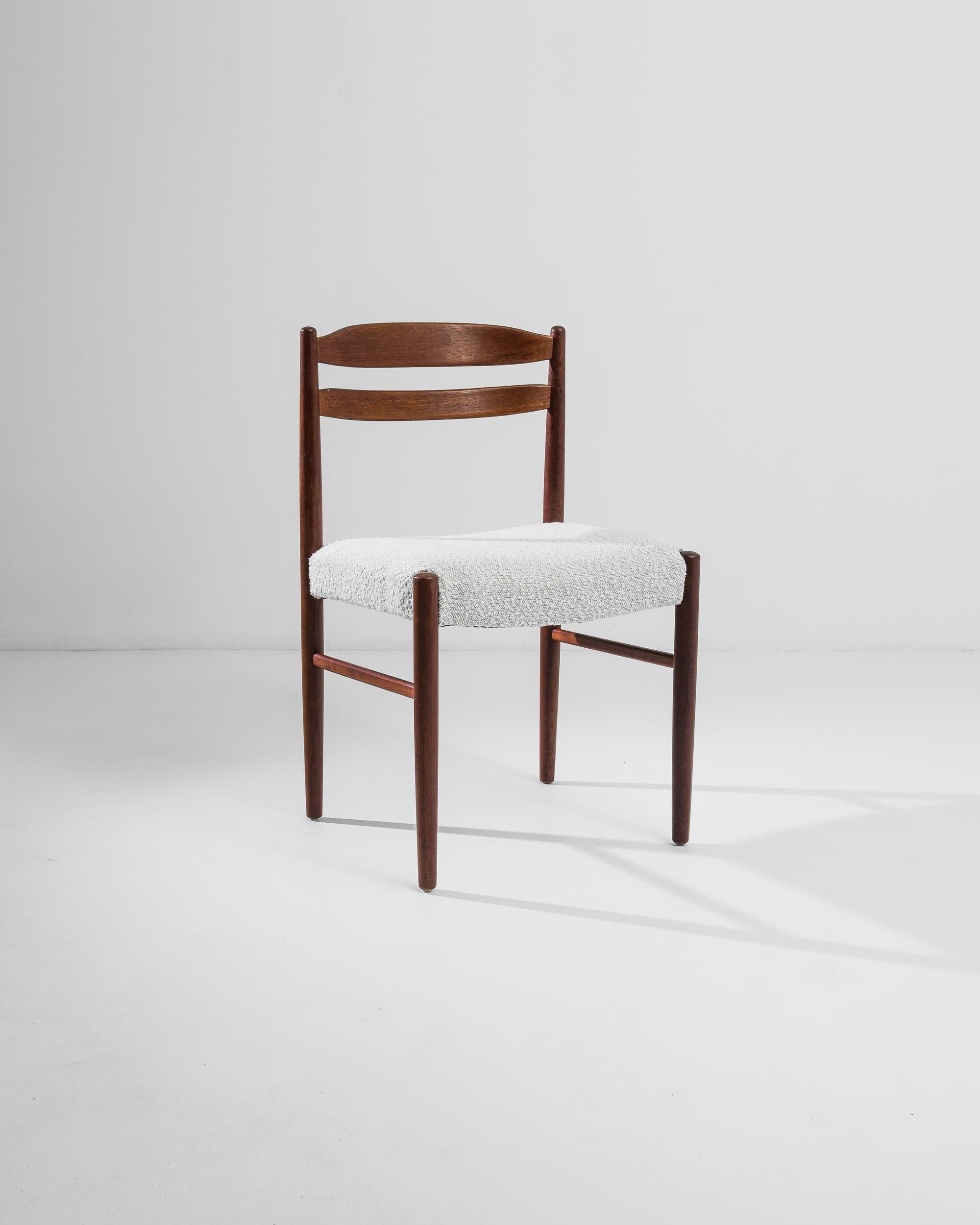 Introducing the epitome of true craftsmanship: our 20th Century Danish Wooden Chair with Upholstered Seat. Crafted with precision and care, this chair exudes timeless elegance and modern sophistication. The rich wood frame showcases the beauty of