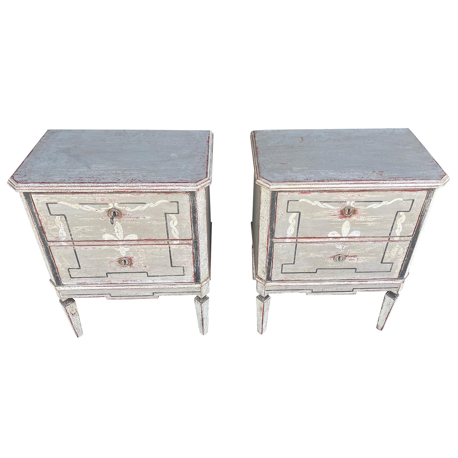 An antique pair of small hand carved Swedish Gustavian chests of drawers made of Pinewood with a dark grey painted finish, Fleur de Lys decor and square tapered legs, in good condition. The Scandinavian nightstands, bedside tables have two drawers