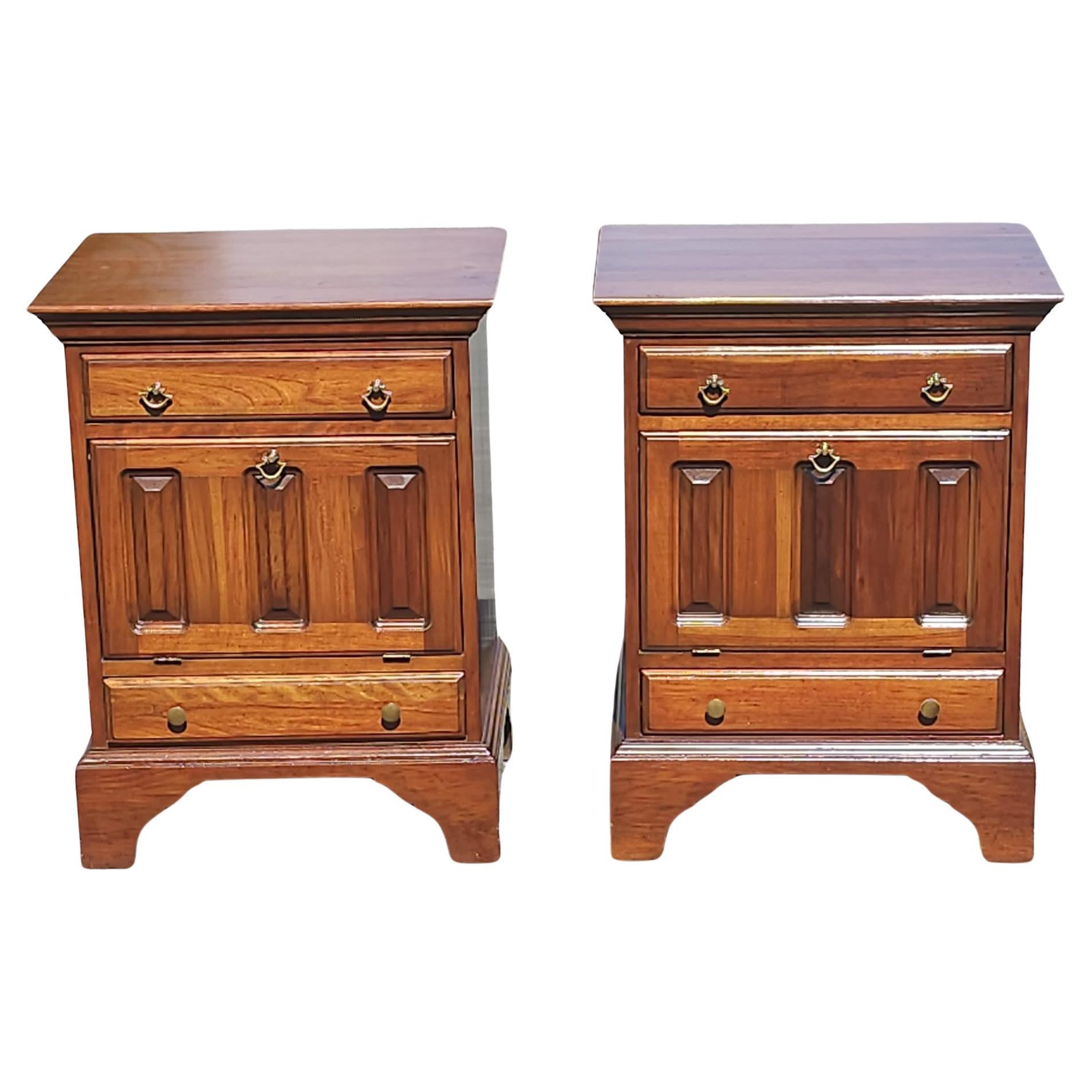 A pair of 20th Century David Cabinet Cherry 2-Drawer a Abattant Door Bedside Cabinets / Nightstands with Protective glass tops. Feature a top drawer, a large storage cabinet with a drop down door and bottom drawer. Both drawer with dovetail joints