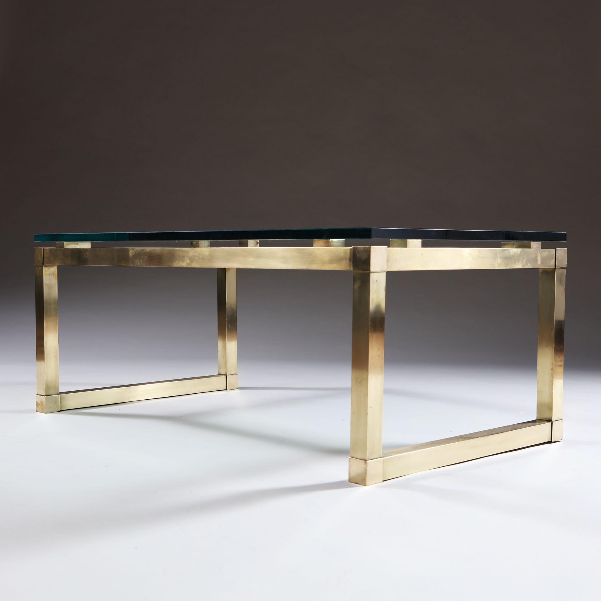 A fine rectangular brass coffee table of angular design, with square brass cushion supports retaining the original glass top. The underside of the rails engraved with a patent and dated 1971. 

A similar table designed and supplied to Chester Roth