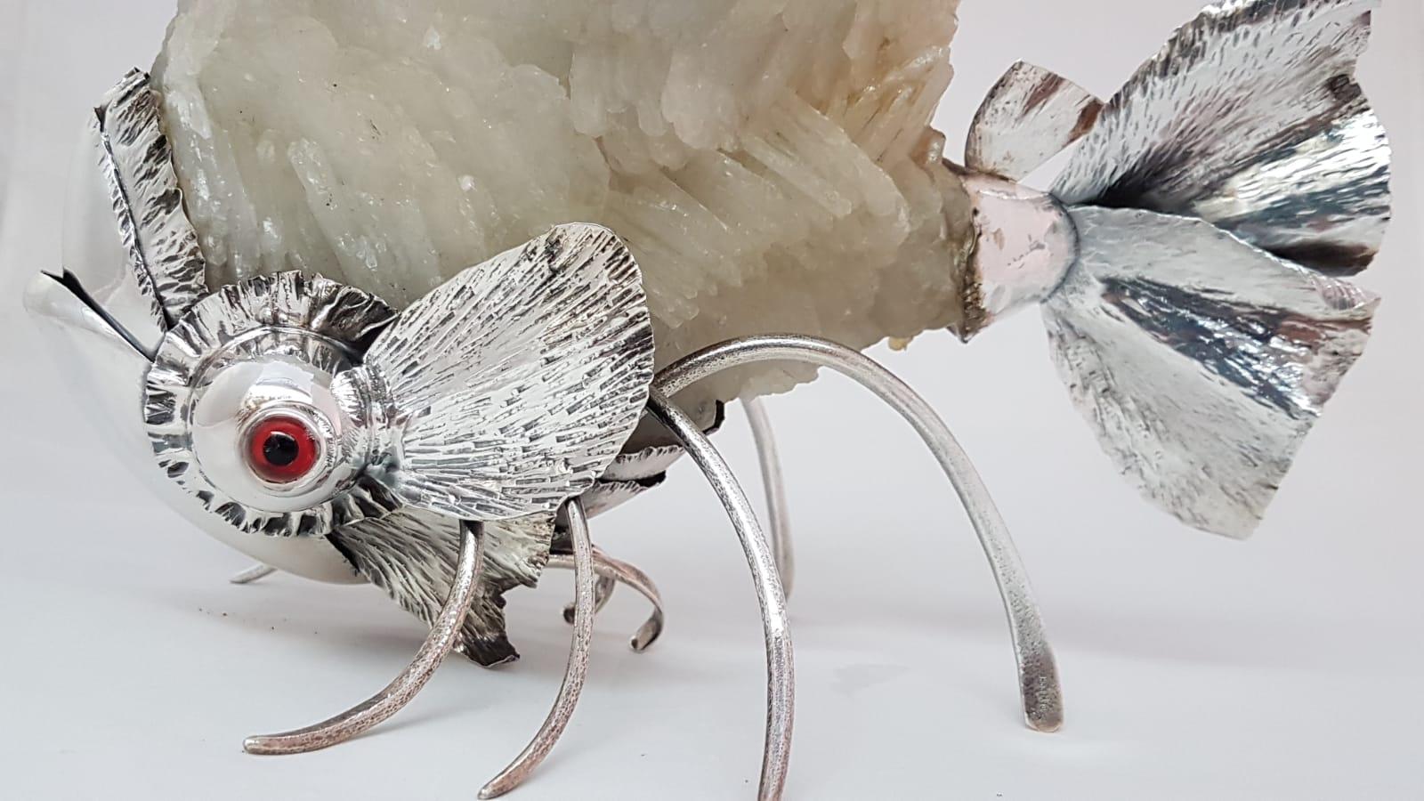 A unique piece of art, a sculpture representing a stylish fish in sterling silver, crystal rock, and precious stones. Signed De Vecchi. Very rare to find. Collectible item.
 