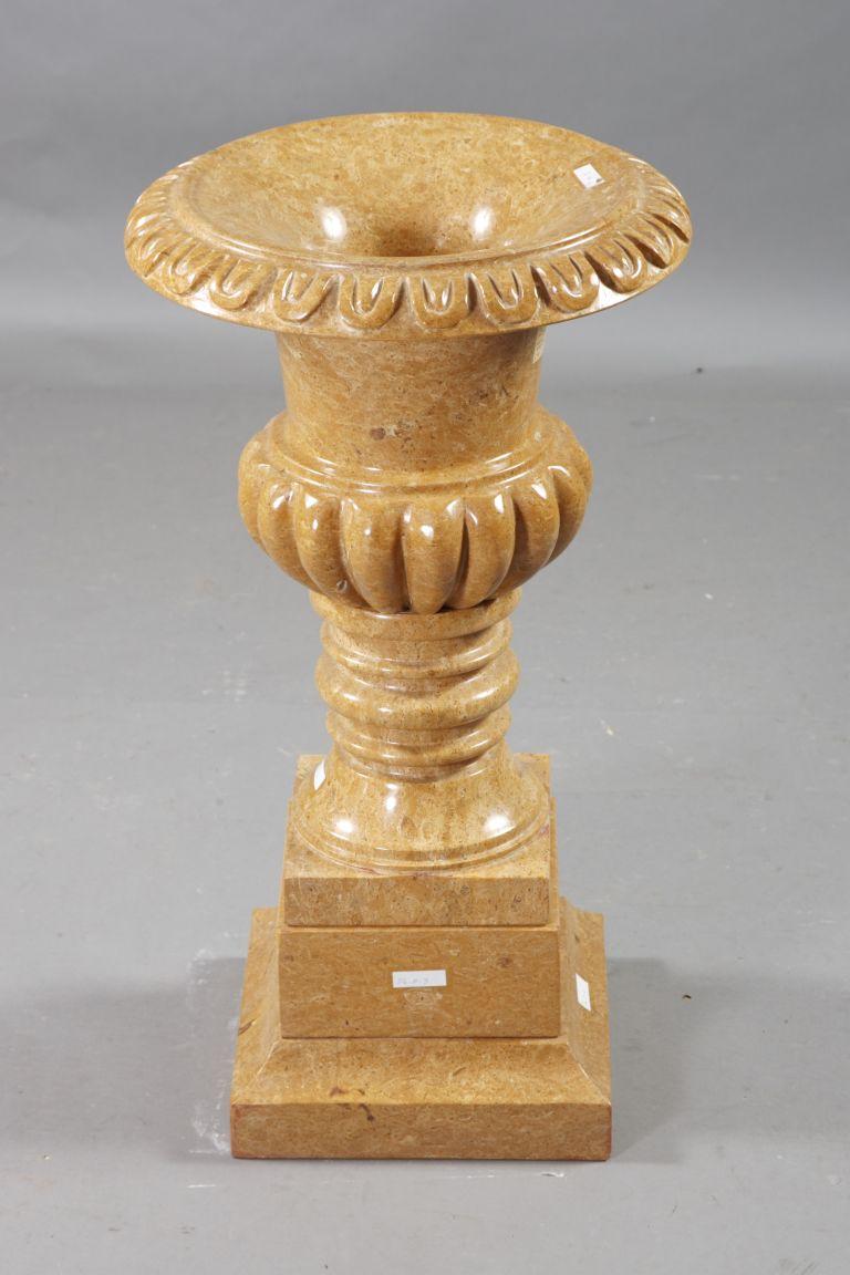 Decorative marble cratervase in the style of classicism

Natural marble in golden yellow. Quadrilateral going into curly shaft. Ovoider body slightly conically rising neck and wide, arched and decorated edge. The entire crater vase is