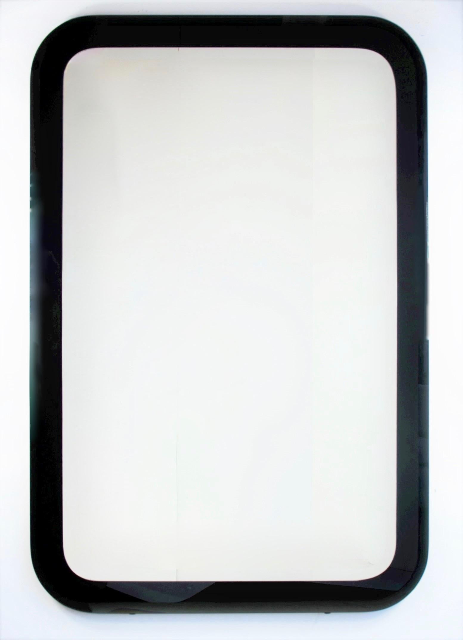 Offered is a 20th century custom decorative rectangle contemporary vintage beveled edge mirror with black glass frame. The generous size and elegant yet simple design of this mirror would be perfect for any genre of decor and in almost any space.